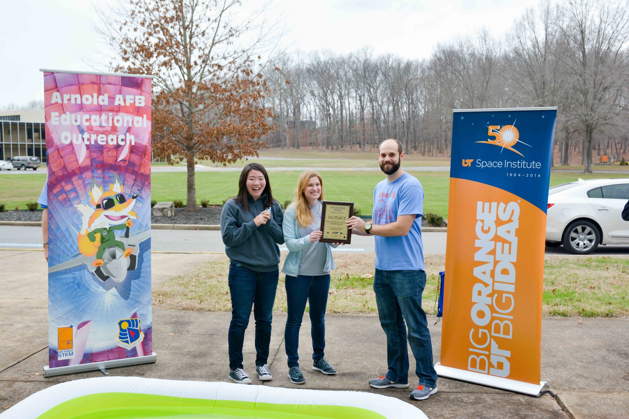 St. Andrews Sewanee students Ester Yang, far left, and Kyra Wilson, second from left, accept the Engineers Week Student Design Competition first place award Feb. 21 from Paul Ritter, AEDC engineer. The competition, held Feb. 21 at the University of Tennessee Space Institute Main Auditorium, was a challenge presented to 25 student teams from 10 schools where they designed and built a vessel to carry cargo across water using provided materials. The teams were judged on the quantity of goods transported and the speed of the delivery. (Courtesy photo)