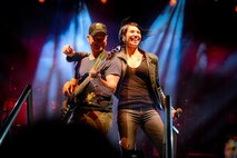 Gary Sinise, the Lt. Dan Band electric bass player, and Molly Callinan, vocalist, take center stage at Barksdale Air Force Base, La. March 3, 2017. The Lt. Dan Band has performed at U.S. military installations since 2004. (U.S. Air Force photo/Airman 1st Class Stuart Bright)