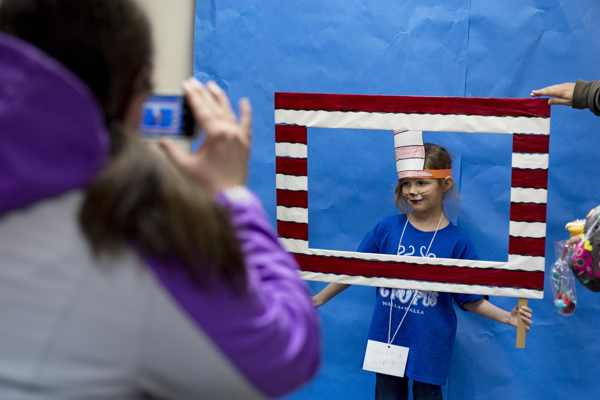 A child gets her photo taken by her mother at West Elementary School during a National Read Across America Day event, Mar. 2, 2017, at Yokota Air Base, Japan. The Dr. Seuss Family Night event at West Elementary School included various activities designed to encourage and show the enjoyment in reading to children. (U.S. Air Force photo by Airman 1st Class Donald Hudson)