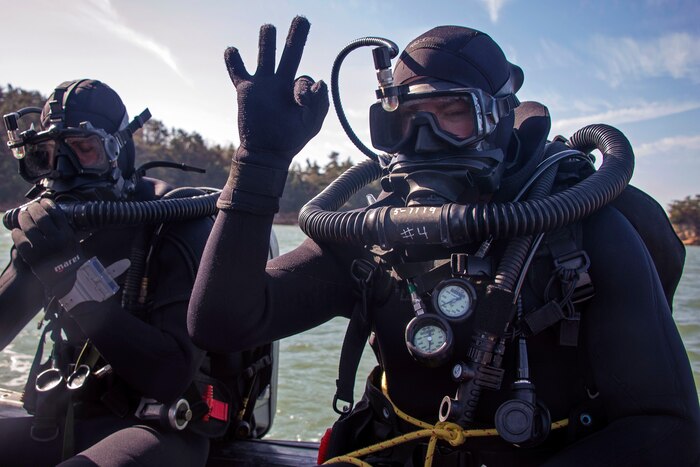 Explosive ordnance disposal technicians assigned to Explosive Ordnance Disposal Mobile Unit 5 prepare to dive off the coast of Jinhae, South Korea during Exercise Foal Eagle 2017, March 3, 2017. Navy photo by Petty Officer 3rd Class Alfred A. Coffield