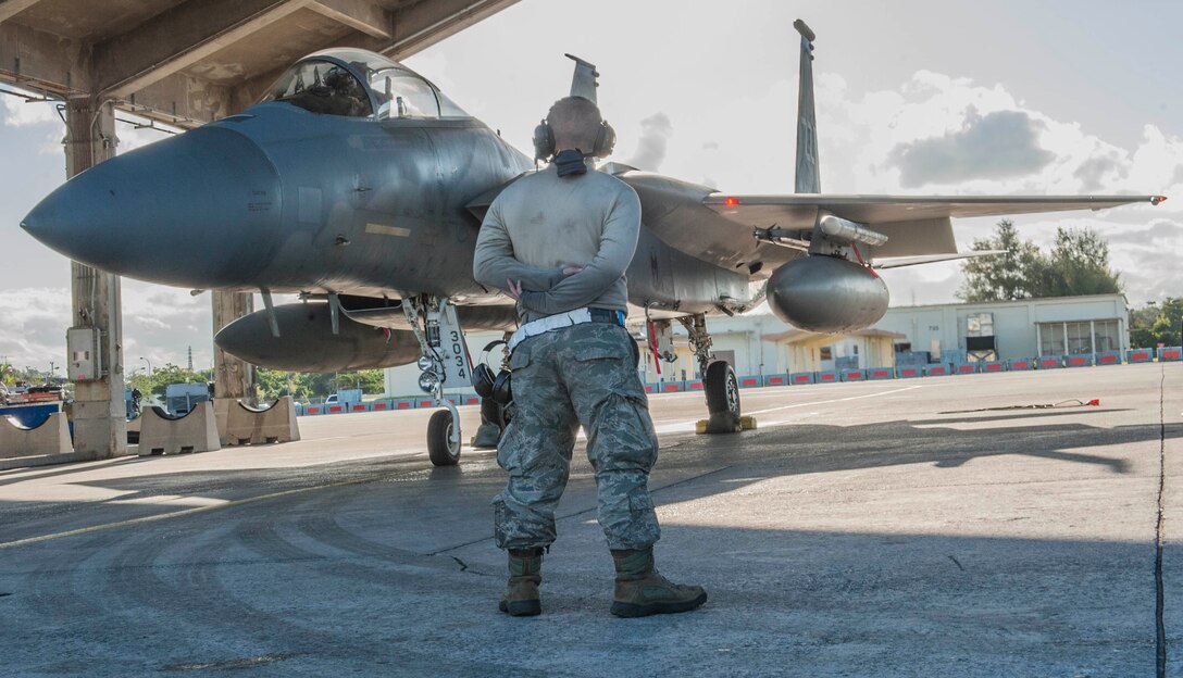 U.S. Air Force Senior Airman Vincent Hassing, a 44th Aircraft Maintenance Unit maintainer, waits as an F-15 Eagle prepares to taxi to the runway, Feb. 14, 2017, on Kadena Air Base, Japan. The 44th AMU and members of the 44th Fighter Squadron participated in an exercise alongside members of the U.S. Navy 27th and 102nd Strike Fighter Squadrons from Naval Air Station Atsugi, Japan. (U.S. Air Force photo by Senior Airman Nick Emerick/Released)