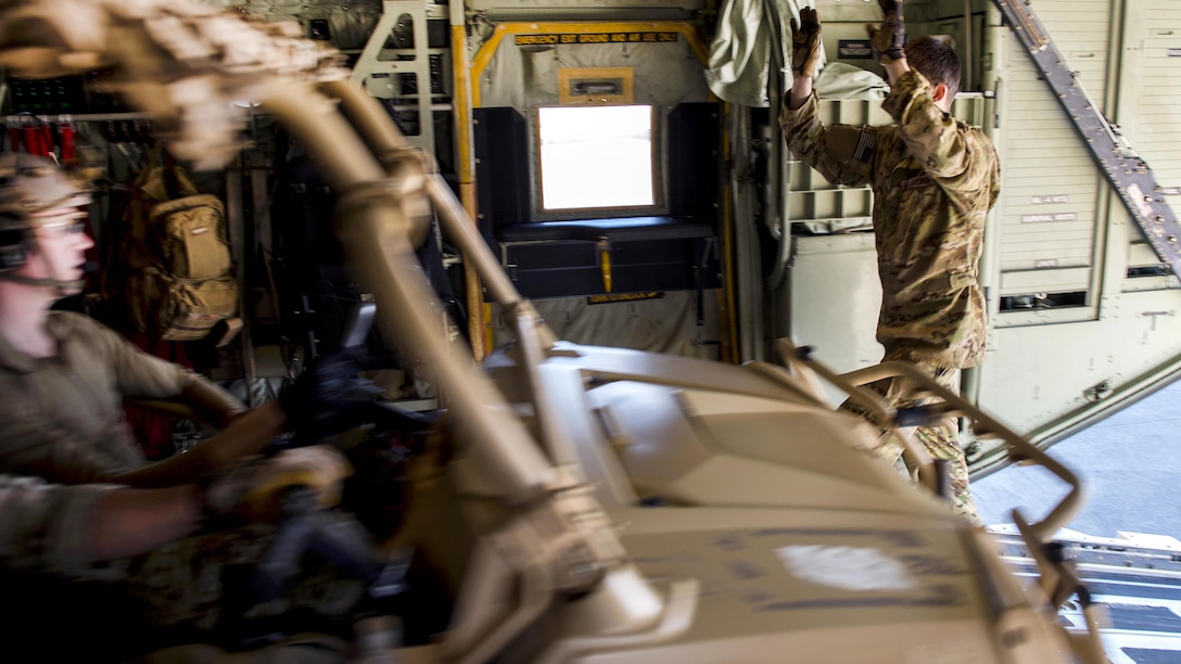 An airman directs the driver of a Polaris MRZR light tactical all-terrain vehicle as he exits an MC-130J Commando II aircraft during static load training as part of the Emerald Warrior 17 exercise at Hurlburt Field, Fla., Feb. 26, 2017. Air Force photo by Senior Airman Erin Piazza