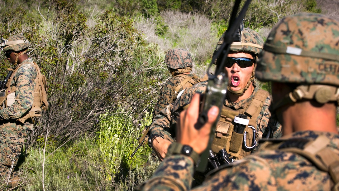 A Marine yells out instructions to his team while attempting to contact a downed pilot during a tactical recovery of aircraft and personnel training mission at Camp Pendleton, Calif., Mar. 1, 2017. Marine Corps photo by Lance Cpl. Frank Cordoba