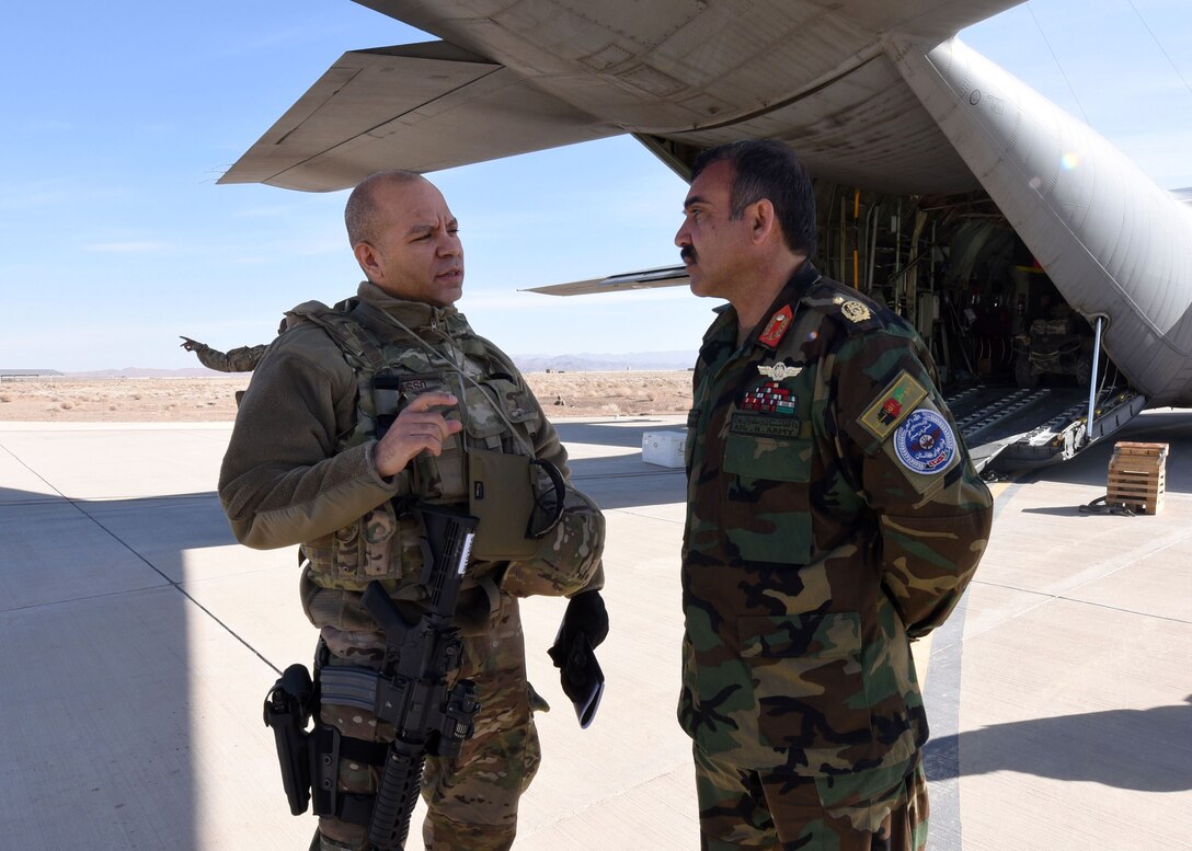 Lt. Col. Jose Lasso, Train, Advise, Assist Command-Air (TAAC-Air) deputy director of logistics, was welcomed by Afghan Air Force Brig. Gen. Abdul Qudratullah, Shindand Air Wing commander, at Herat, Afghanistan, March 1, 2017. The meeting was an opportunity for TAAC-Air advisors in various career fields from logistics, maintenance, safety, intelligence, civil engineer and C-130 flight crews to meet with their counterparts to train and advise, as well as assess the current mission. (U.S. Air Force photo by Tech. Sgt. Veronica Pierce) 