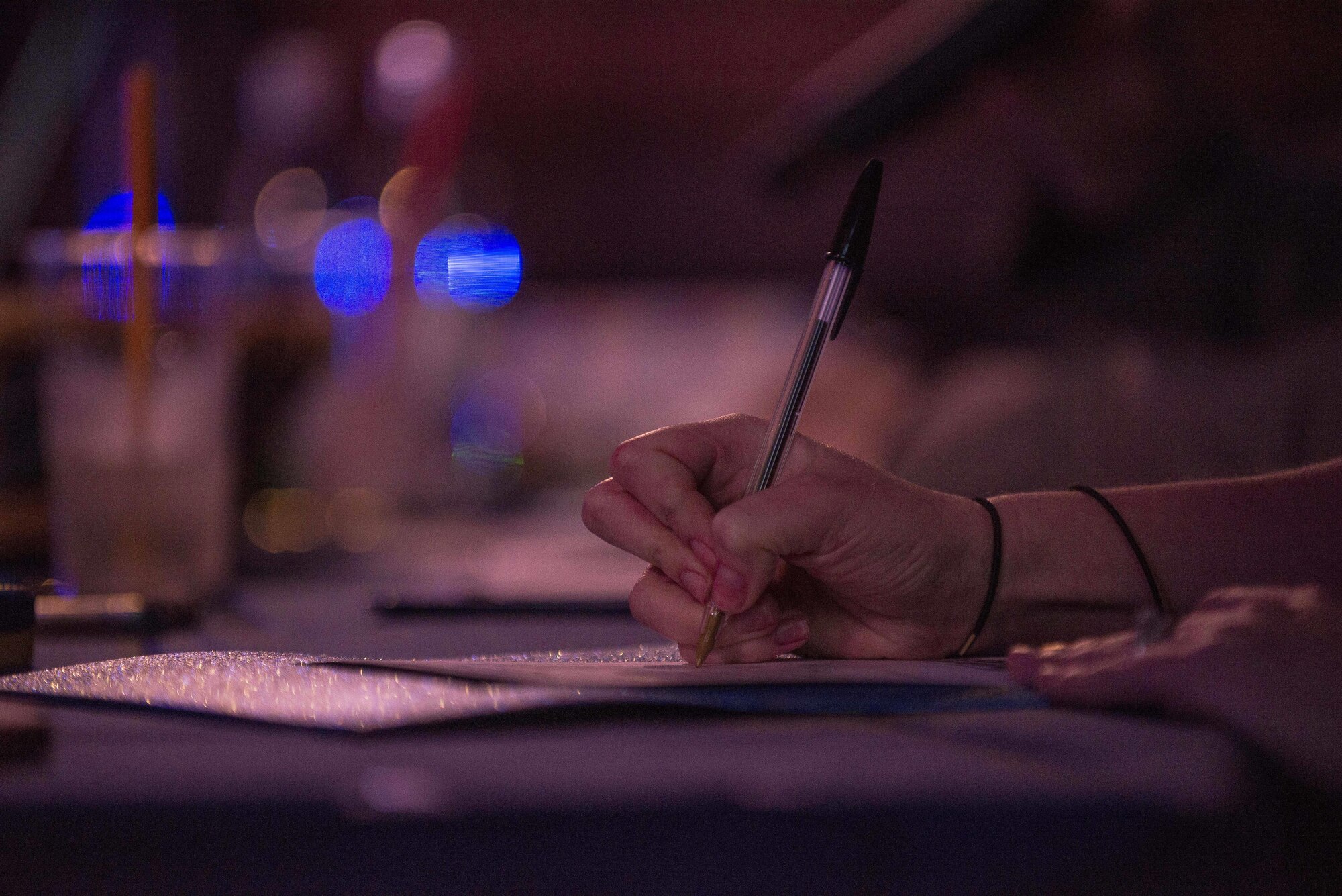 Britney Manning, Aviano’s Got Talent judge, writes a comment on a contestant’s scorecard during the Aviano’s Got Talent finale, March 2, 2017, at Aviano Air Base, Italy. Manning was chosen to be a judge because of her 20 years of competitive performance. (U.S. Air Force photo by Senior Airman Cory W. Bush)
