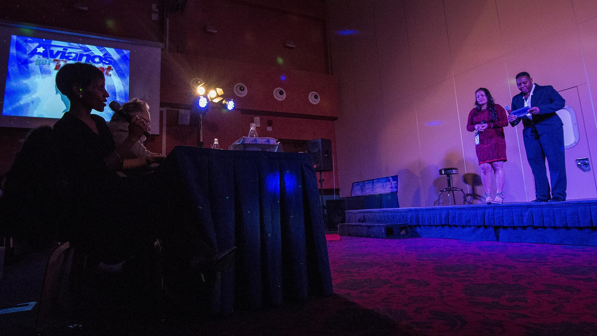Col. Jenise Carroll talks after a performance by Anabella Swarts, during the Aviano’s Got Talent finale, March 2, 2017, at Aviano Air Base, Italy. Carroll is the 31st Mission Support Group commander and was one of five judges who critiqued contestant’s performances throughout the competition. (U.S. Air Force photo by Senior Airman Cory W. Bush)
