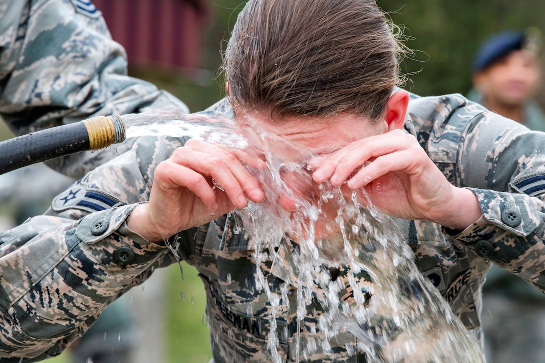 Air Force Airman 1st Class Kameron Freeman washes her eyes after being pepper sprayed during training at McLaughlin Air National Guard Base, W.Va., March 4, 2017. Freeman is assigned to the 130th Airlift Wing Security Forces Squadron. Security forces members must train to experience pepper spray and deal with its effects. Air National Guard photo by Tech. Sgt. De-Juan Haley