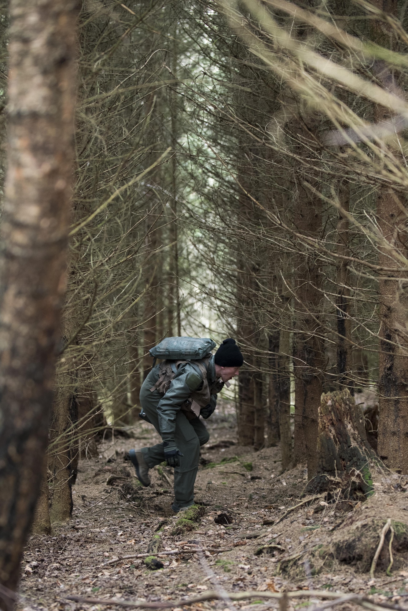 A U.S. Air Force pilot assigned to the 480th Fighter Squadron walks through a wooded area during Survival, Evasion, Resistance and Escape training near Spangdahlem Air Base, Germany, March 3, 2017. SERE was established by the U.S. Air Force at the end of World War II and was extended and consolidated during the Vietnam War to the U.S. Marine Corps, U.S. Navy and in the late 1980s to the U.S. Army. (U.S. Air Force photo by Airman 1st Class Preston Cherry)
