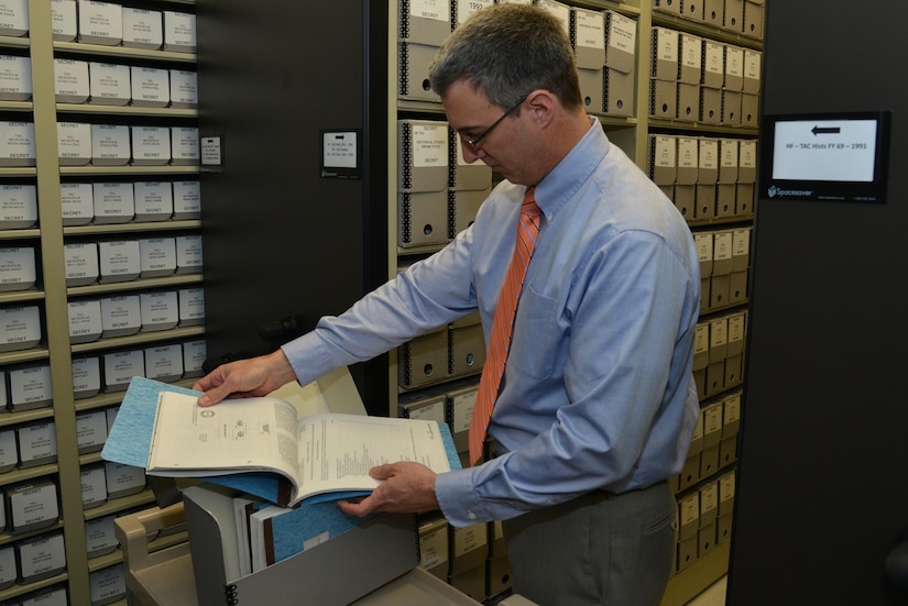 Bill Butler, Air Combat Command deputy command historian, searches through records at Joint Base Langley-Eustis, Va., Jan. 24, 2017. The ACC historian archives contain information dating back to the beginning of Langley Field. (U.S. Air Force photo by Airman 1st Class Tristan Biese)