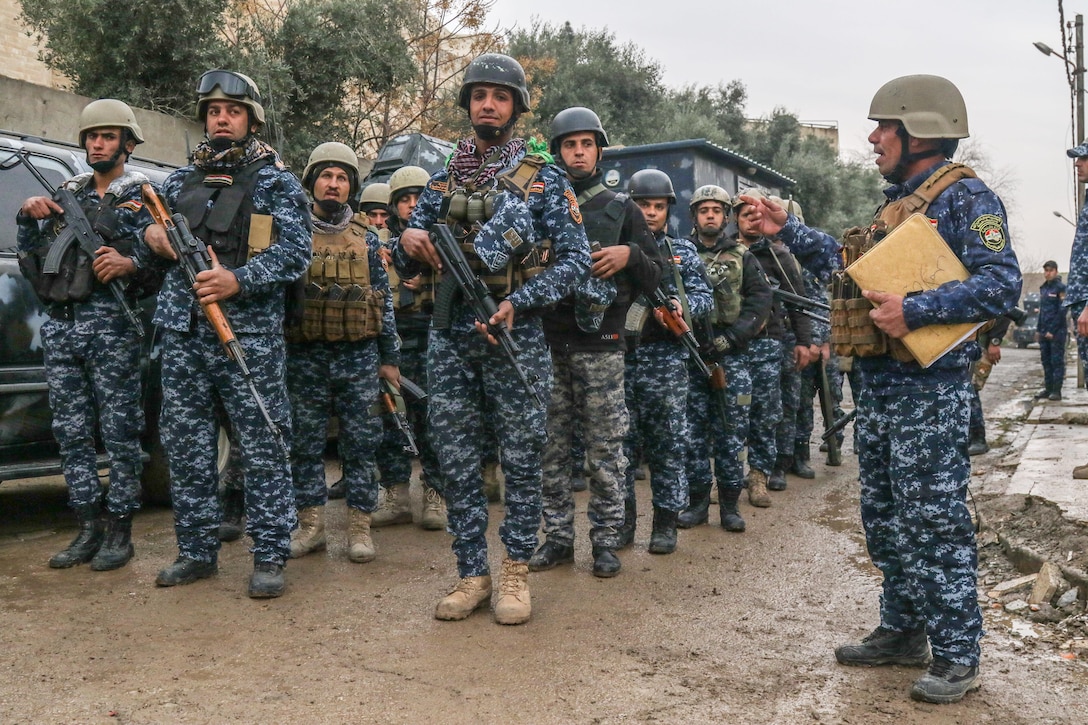 Iraqi federal police stand in formation in West Mosul, Iraq, March 2, 2017. The breadth and diversity of partners supporting the Coalition demonstrate the global and unified nature of the endeavor to defeat ISIS. Combined Joint Task Force-Operation Inherent Resolve is the global Coalition to defeat ISIS in Iraq and Syria. (U.S. Army photo by Staff Sgt. Jason Hull)