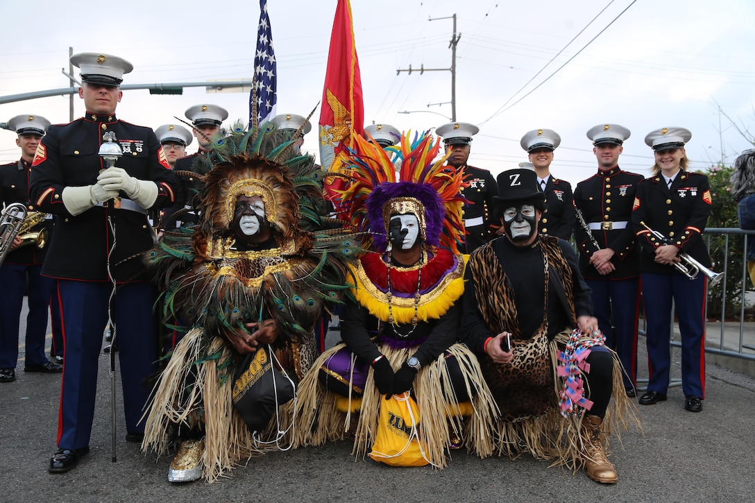 Members of the Zulu Social Aid and Pleasure Club take a photo with the 2nd Marine Aircraft Wing Band during Mardi Gras festivities in New Orleans, Feb. 28, 2017. The 2nd MAW band provided music and was a face of the Marine Corps during the parade. The Zulu Social Aid and Pleasure Club contributes to the local community in numerous different ways including providing Christmas baskets to needy families and donating funds and time to other community organizations. (U.S. Marine Corps photo by Lance Cpl. Cody Lemons/Released)
