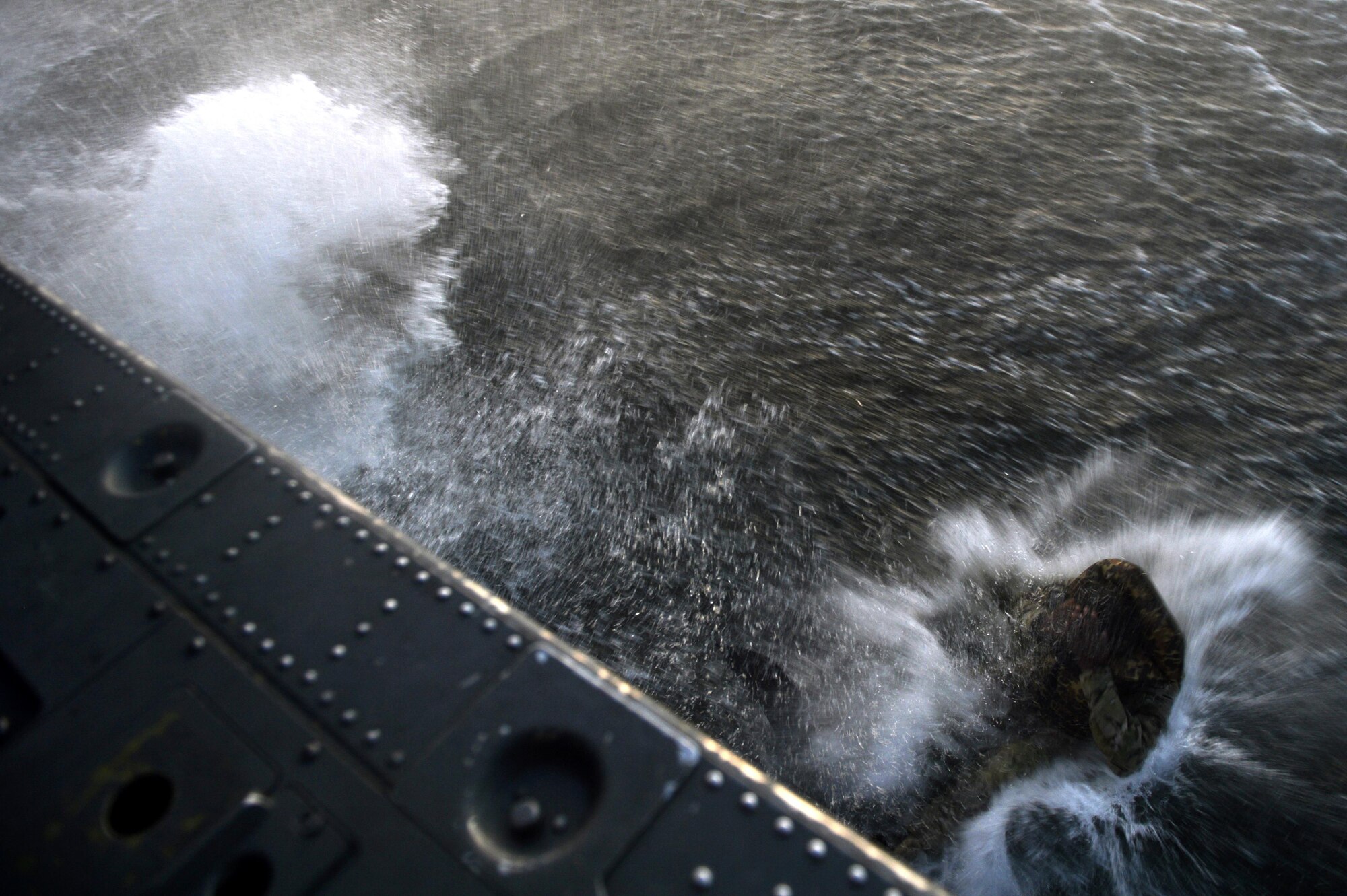 A U.S. Army Solider from the 7th Special Forces Group performs an over water jump during Emerald Warrior 17 March 2, 2017, at Hurlburt Field, Fla. Emerald Warrior is a U.S. Special Operations Command exercise during which joint special operations forces train to respond to various threats across the spectrum of conflict. (U.S. Air Force photo by Staff Sgt. Michael Battles)