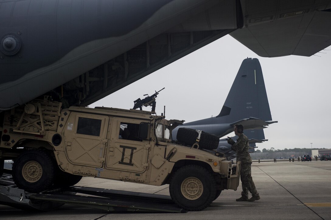 A U.S. Air Force Airman assigned to the 9th Special Operations Squadron loads a Humvee onto an MC-130J Commmando II during Emerald Warrior 17 at Hurlburt Field, Fla., Feb. 28, 2017. Emerald Warrior is a U.S. Special Operations Command exercise during which joint special operations forces train to respond to various threats across the spectrum of conflict. (U.S. Air Force photo by Staff Sgt. Corey Hook)
