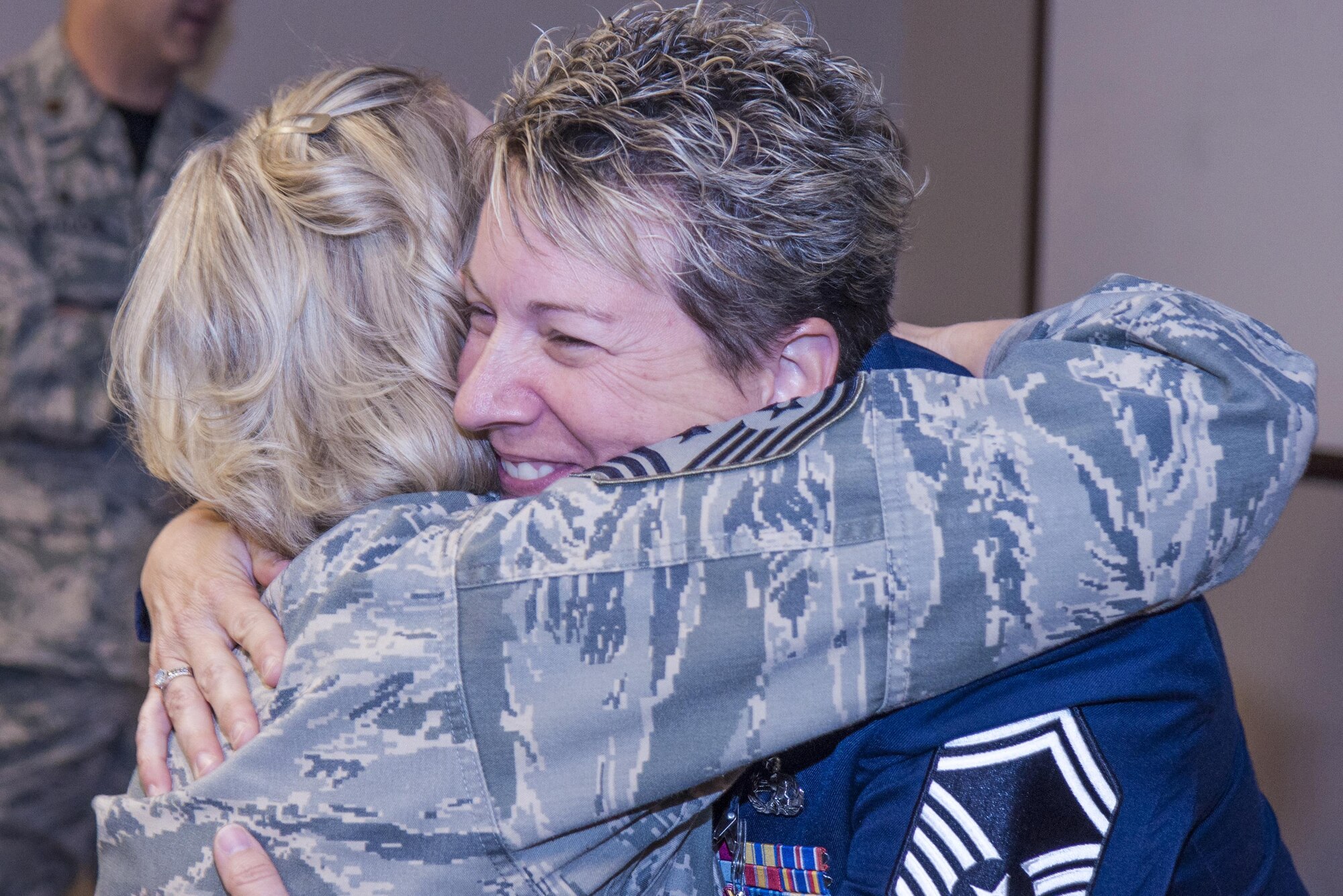U.S. Air Force Senior Master Sgt.  Lisa K. Vanderhoff, 307th Maintenance Squadron structural mechanic, hugs Chief Master Sgt. Shelley Cohen, 307th Bomb Wing command chief, at Barksdale Air Force Base, La., March 4, 2017.  Cohen was part of a large group gathered for Vanderhoff’s retirement ceremony.  Vanderhoff retired after serving 23 years in the Air Force. (U.S. Air Force photo by Technical Sgt. Cody Burt/Released)