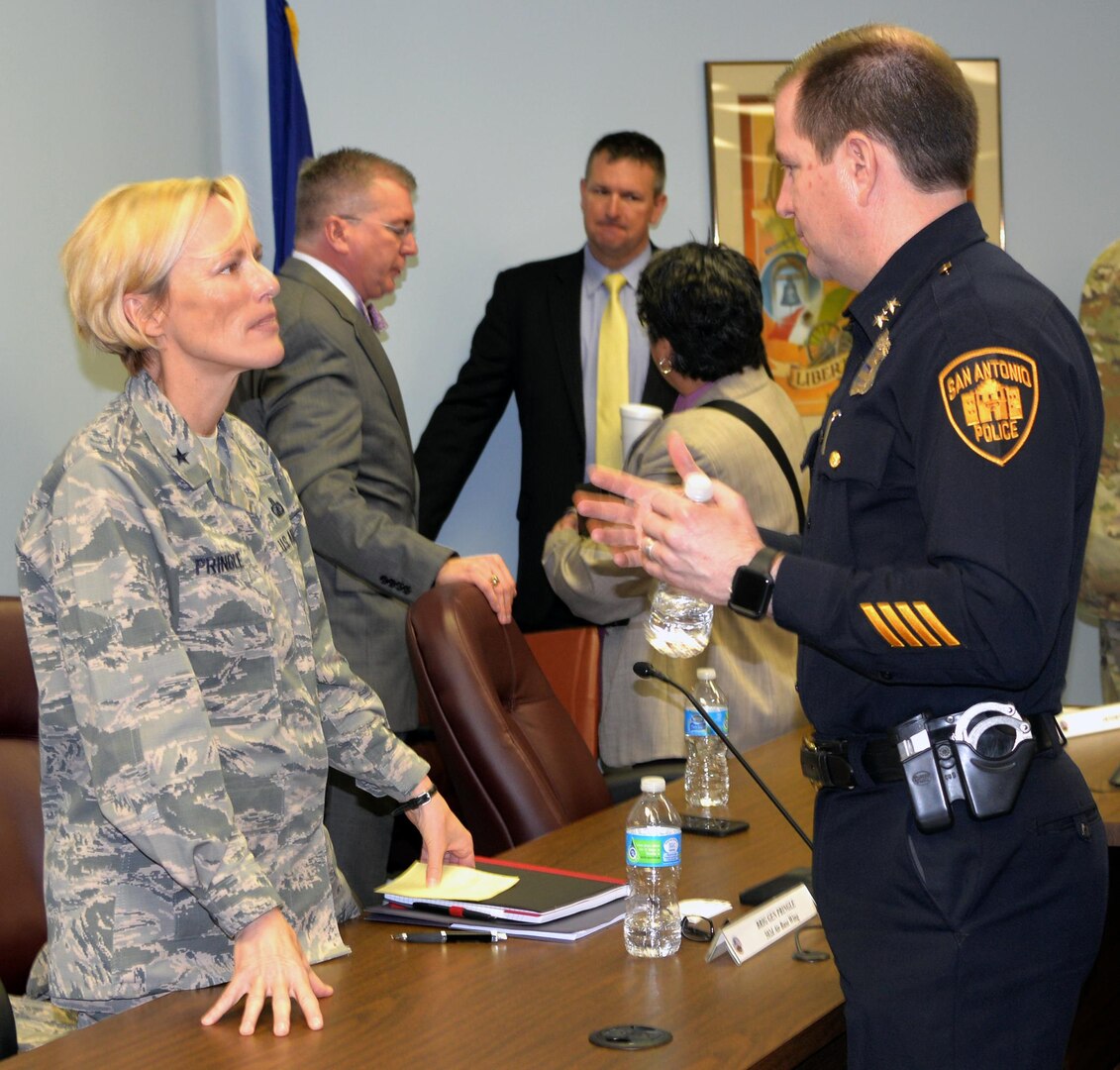 Brig. Gen. Heather L. Pringle (left), 502nd Air Base Wing and Joint Base San Antonio commander, speaks with San Antonio Police Department Assistant Chief Anthony Trevino (right) during the Air Force Community Partnership Program Public-Public; Public-Private Partnerships Refresh Meeting at the Alamo Area Council of Governments Feb. 8.
