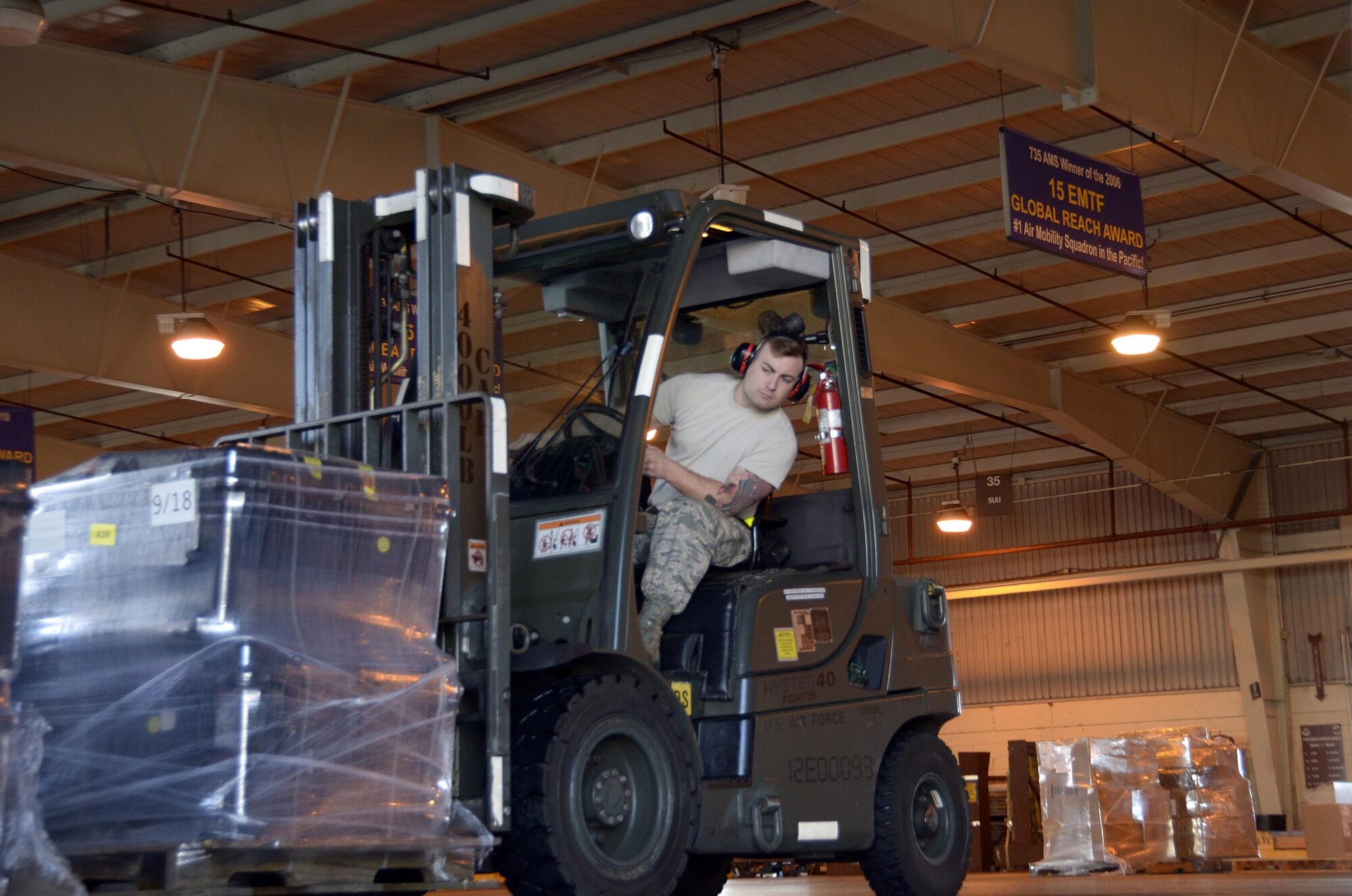 Staff Sgt. Zachary Smith, 87th Aerial Port Squadron air transportation journeyman, operates a forklift during his annual training at Joint Base Pearl Harbor-Hickam, Hawaii, February 13, 2017. Members unload trucks and palletize the shipments for cargo planes. The 87th APS sent 26 reservists to Hawaii for their annual tour. (U.S. Air Force photo/Staff Sgt. Joel McCullough)