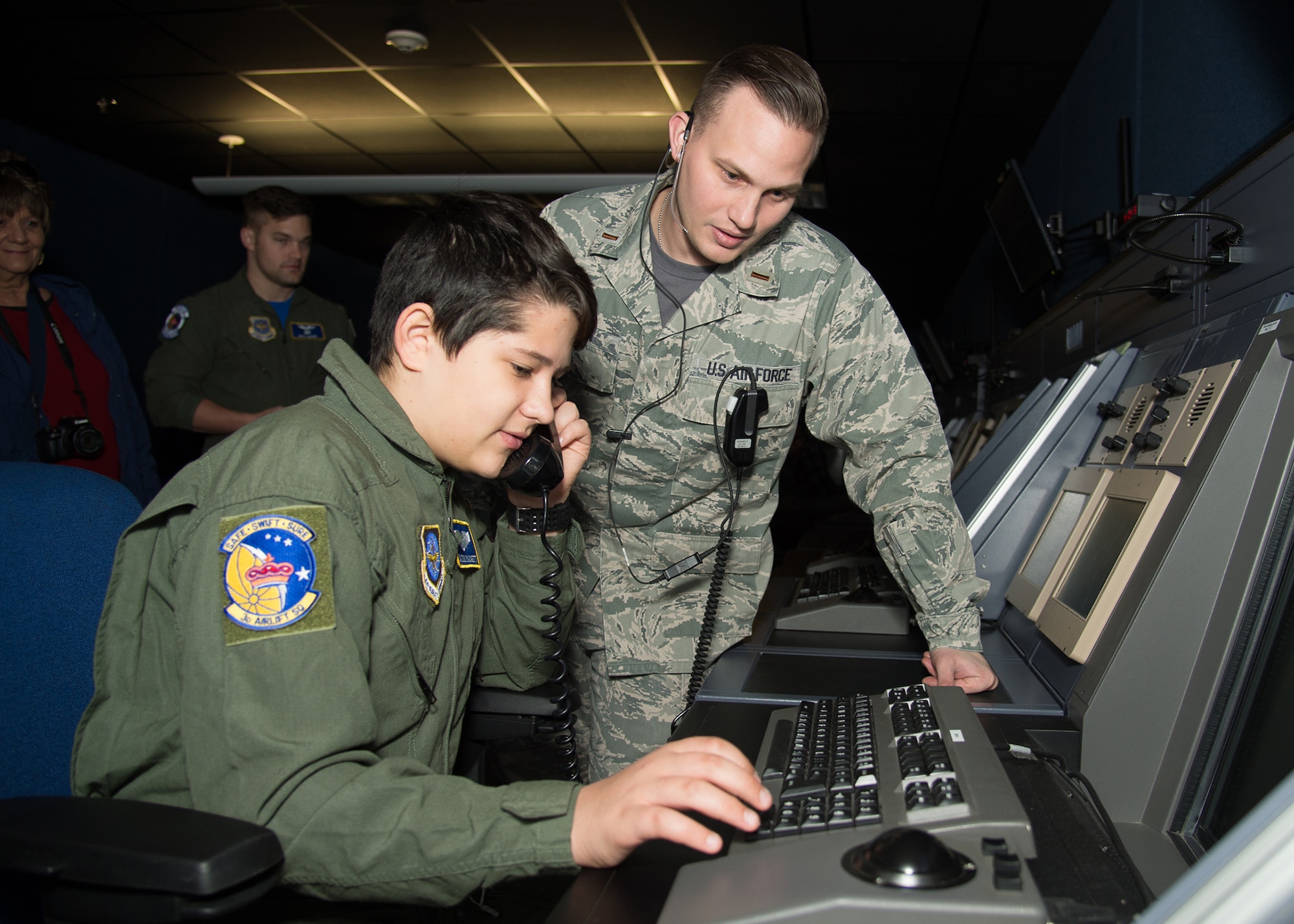 Second Lt. Charles Newman, 436th Operations Support Squadron, shows Dalton Padgett the Radar Approach Control room during his Pilot for a Day tour Mar. 3, 2017, at Dover Air Force Base, Del. Padgett was able to track aircraft location, altitude, speed, as well as learn how they are vectored for approach. (U.S. Air Force photo by Mauricio Campino)