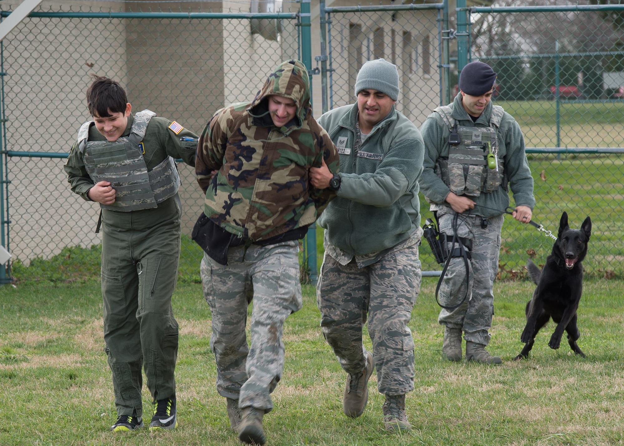 Dalton Padgett and members of the 436th Security Forces Squadron apprehend an assailant during a training exercise Mar. 3, 2017, at Dover Air Force Base, Del. Padgett got to meet and train with military working dogs, toured the kennels and saw the various weapon systems used by security forces. (U.S. Air Force photo by Mauricio Campino)