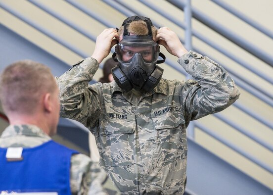 A member of the 366th Logistics Readiness Squadron dons his gas mask during an exercise Feb. 28, 2017, at Mountain Home Air Force Base, Idaho. There is a specific order in which their protective gear must be applied to ensure speed and safety. (U.S. Air Force photo by Airman Jeremy D. Wolff/Released)