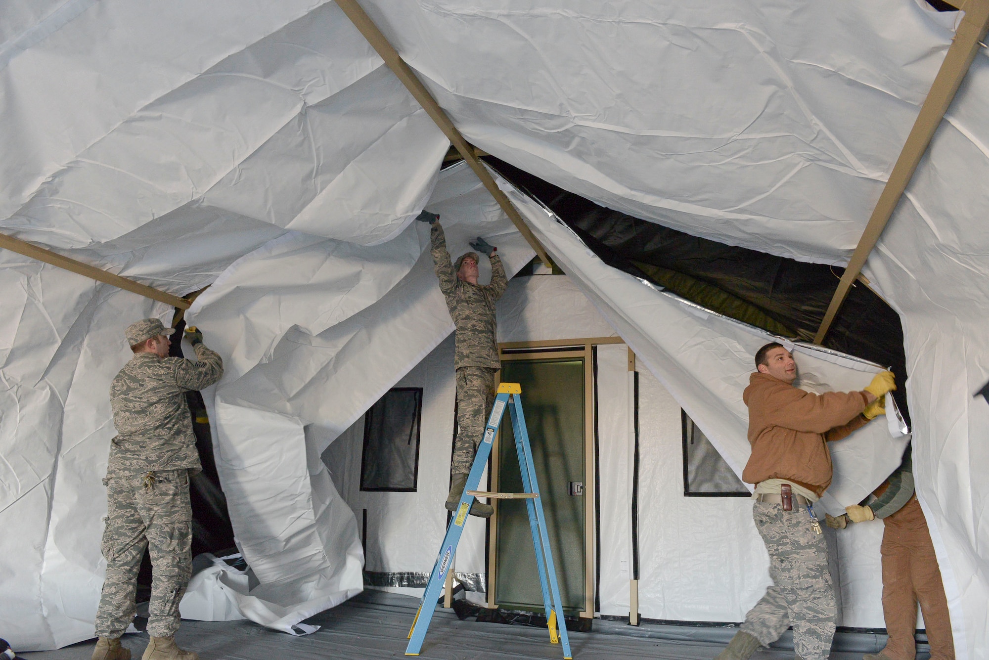 Members of the 366th Civil Engineer Squadron construct a tent during an exercise at Mountain Home Air Force Base, Idaho. The focus of the base wide exercise was mission readiness and took place from Feb. 28 through March 2. (U.S. Air Force photo by Airman Jeremy D. Wolff/Released)