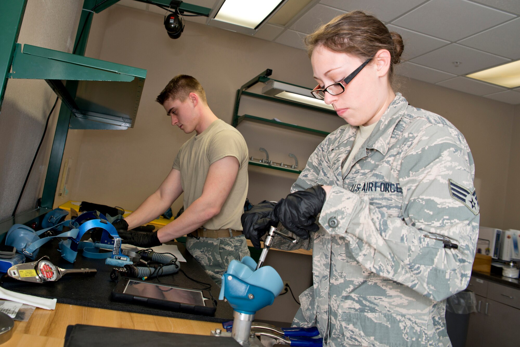 U.S. Air Force Reserve Senior Airman Bobbi Reader, an aircrew flight equipment technician assigned to the 913th Operations Support Squadron, removes a locking valve nut from the hard-shell assembly of a Scott 358 Quick Don Oxygen Mask March 4, 2017, at Little Rock Air Force Base, Ark. The Scott 358, which is a fully integrated oxygen and smoke protection system, can be donned using a single hand in less than five seconds during an emergency. (U.S. Air Force photo by Master Sgt. Jeff Walston/Released)