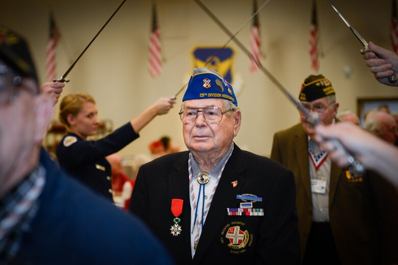A veteran crosses through a saber arch during the 38th Veterans’ Luncheon at Barksdale Air Force Base, La., March, 3, 2017. Veterans were greeted by 2nd Bomb Wing leadership and special guests during the Parade of Heroes. (U.S. Air Force photo/Senior Airman Mozer O. Da Cunha)