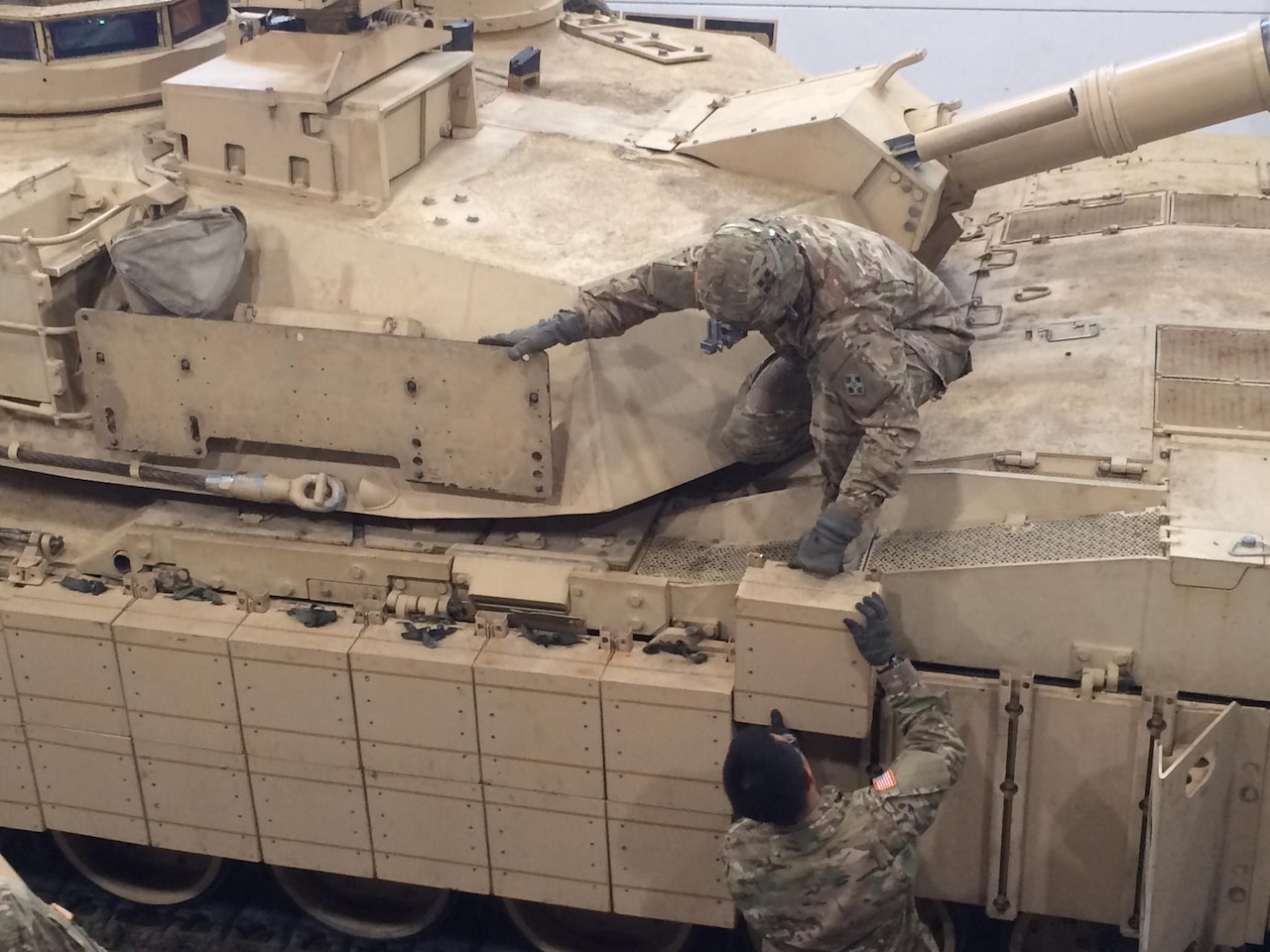 Tank and maintenance crews with 1st Battalion, 66th Armor Regiment, install reactive armor tiles onto a M1A2 Abrams tank at the 7th Army Training Command's Grafenwoehr Training Area, Germany, Feb. 28, 2017. The installation of the Abrams Reactive Armor Tile system will enhance the tank's defensive capabilities, providing a greater deterrent against aggression as the 3rd ABCT maintains a persistent presence in Central and Eastern Europe as the rotational ABCT for Atlantic Resolve. Army photo by Capt. (Chaplain) Malcolm Rios