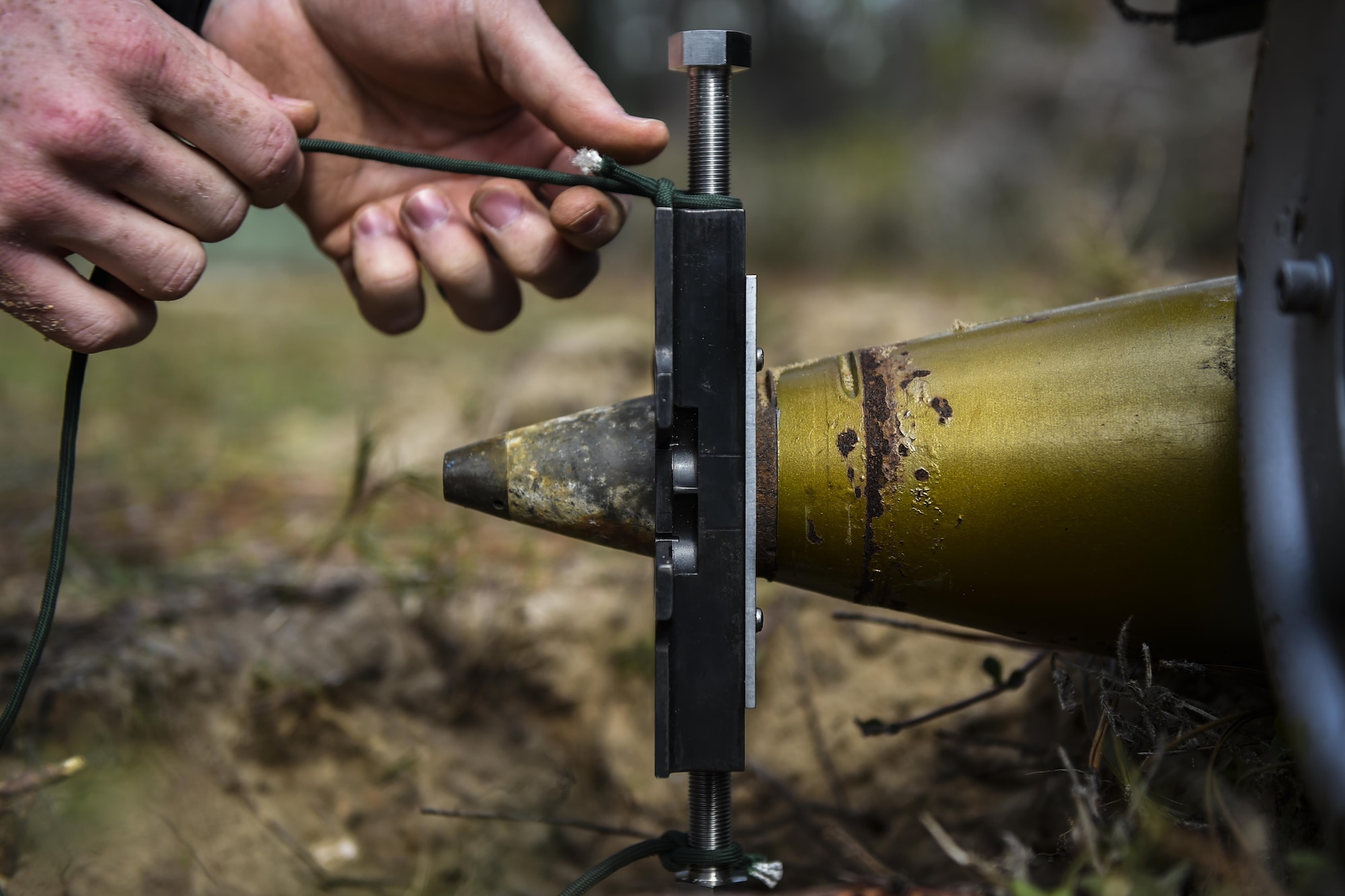 Airman 1st Class Lawrence Gress, an explosive ordinance disposal journeyman with the 1st Special Operations Civil Engineer Squadron, fastens 550 paracord to a MK1 rocket wrench during EOD tool training at Hurlburt Field, Fla., Mar. 6, 2017. EOD specialists are trained to detect, disarm, detonate and dispose explosive threats. (U.S. Air Force photo by Airman 1st Class Joseph Pick)