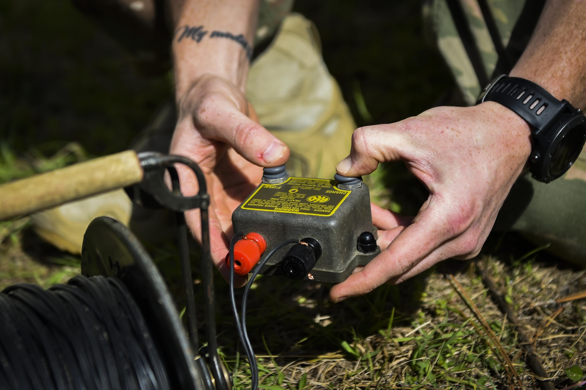 Airman 1st Class Lawrence Gress, an explosive ordinance disposal journeyman with the 1st Special Operations Civil Engineer Squadron, uses a CD450-4J Blasting Machine to detonate a MK1 rocket wrench during EOD tool training at Hurlburt Field, Fla., Mar. 6, 2017. The electrical detonation of the two .50-caliber blank rounds causes the rocket wrench to spin rapidly, removing the fuse attached to the ordnance in the process. (U.S. Air Force photo by Airman 1st Class Joseph Pick)