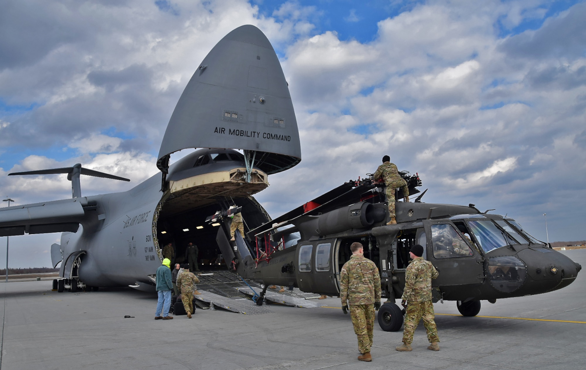 U.S. Army 10th Combat Aviation Brigade Soldiers prepare to load a UH-60 Blackhawk onto an Air Mobility Command C-5M Super Galaxy flown by the Air Force Reserve Command's 68th Airlift Squadron Feb. 27, 2017 on Ft. Drum, N.Y. in support of Operation Atlantic Resolve. (U.S. Air Force photo/Tech. Sgt. Carlos J. Trevino)