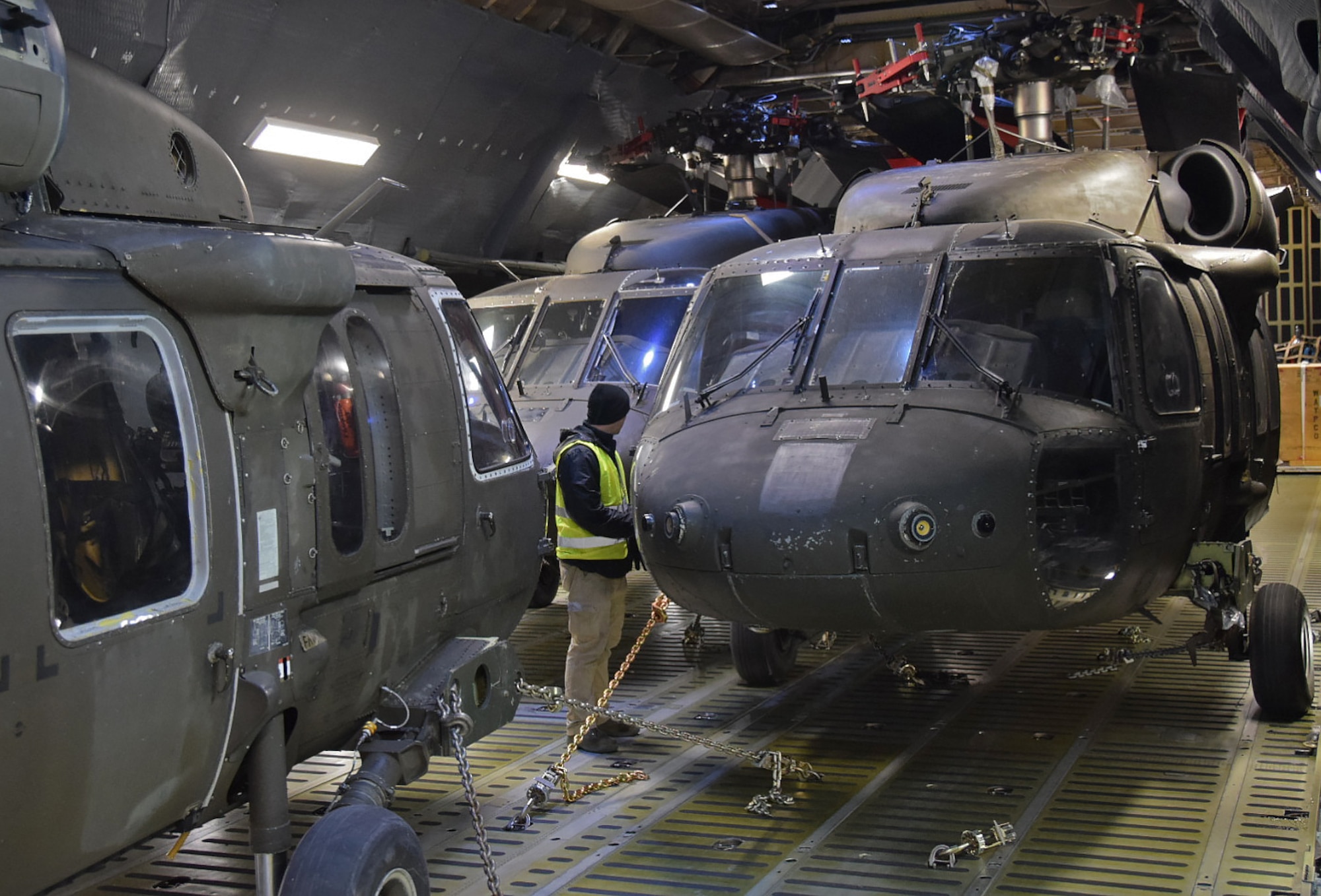 Three U.S. Army UH-60 Blackhawk helicopters belonging to the 10th Combat Aviation Brigade from Ft. Drum, N.Y. are secured and readied for transport on an Air Mobility Command C-5M Super Galaxy on Feb., 27, 2017.  The helicopters and 22 Army Soldiers were flown by Air Force Reserve Command's 68th Airlift Squadron to Riga, Latvia as part of Operation Atlantic Resolve. (U.S. Air Force photo/Tech. Sgt. Carlos J. Trevino)