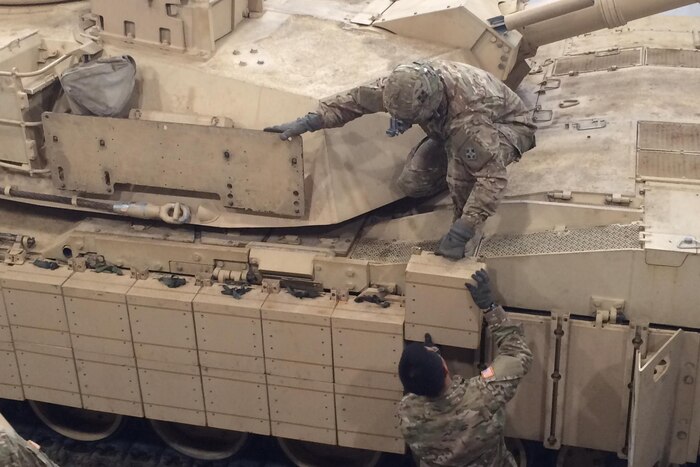 Tank and maintenance crews with 1st Battalion, 66th Armor Regiment, install reactive armor tiles onto a M1A2 Abrams tank at the 7th Army Training Command's Grafenwoehr Training Area, Germany, Feb. 28, 2017. Army photo by Capt. Malcolm Rios