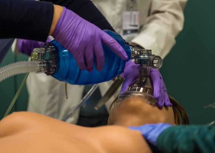 Master Sgt. Barbara Lay, 60th Medical Group, and Capt. Andrew Morton, 82nd Medical Operations Squadron, stabilize the airway of a Athena, the first-ever simulator of its type to be utilized in the Department of Defense, in St. Louis, Missouri.  The simulator has female features and offers advanced ventilation technology, serving as a vital piece to providing the best medical training possible for students completing the program.  (U.S. Air Force Photo / SSgt Jodi Martinez)