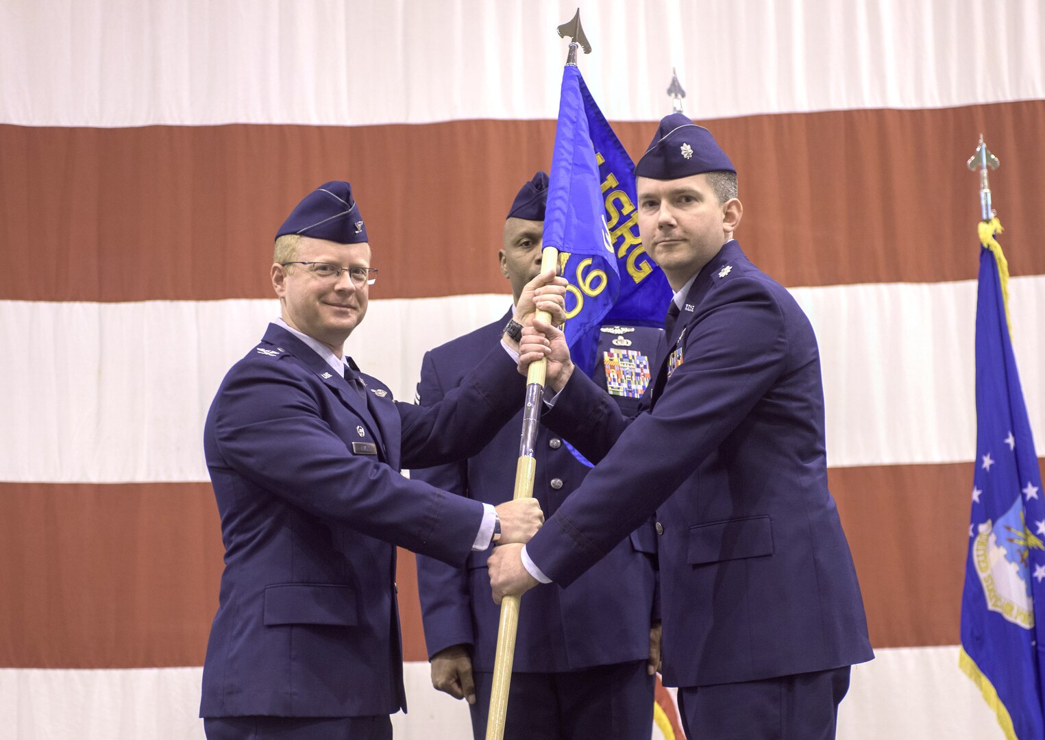 Col. Matthew Atkins, 361st Intelligence, Surveillance and Reconnaissance Group Commander, Hurlburt Field, Florida, and Lt. Col. Stephen McFadden, 306th Intelligence Squadron commander, participate in an assumption of command ceremony hosted by the 137th Special Operations Wing, March 6, 2017, at Will Rogers Air National Guard Base, Oklahoma City. Lt. Col. Stephen McFadden took command of the 306th Intelligence Squadron, formerly located at Beale Air Force Base, California, upon its activation at WRANGB. (U.S. Air National Guard photo by Staff Sgt. Kasey Phipps)