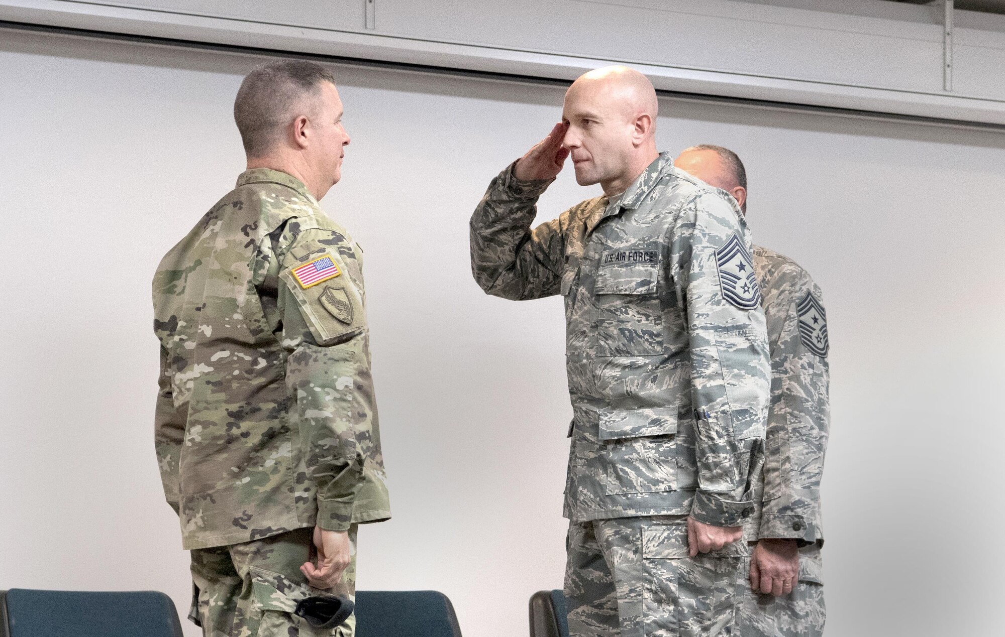 Chief Master Sgt. James Dixon, incoming state Command Chief Master Sgt., salutes Maj. Gen. James A. Hoyer, The Adjutant General of the West Virginia National Guard, signifying his assumption of responsibility for the enlisted force of the WVNG during a change of responsibility ceremony held Feb. 4, 2017 at McLaughlin Air National Guard Base, Charleston, W.Va. Dixon replaced outgoing state Command Chief Master Sgt. Fred Turner, Jr. (U.S. Air National Guard photo by Capt. Holli Nelson)