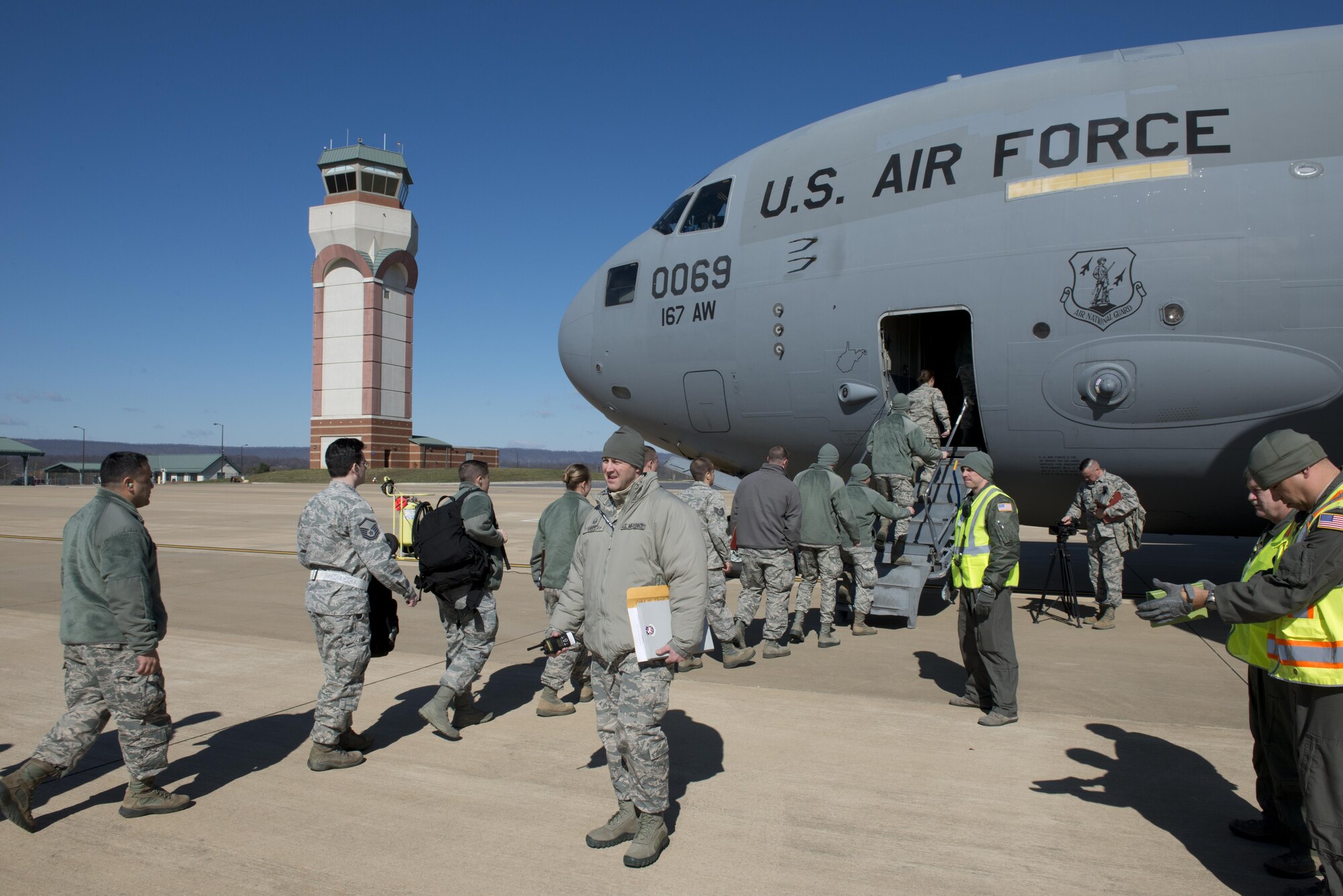 Airmen from the 167th Airlift Wing board a C-17 Globemaster III aircraft while members of the wing inspection team observe during a mobility exercise at the Martinsburg, W.Va. air base March 4. The exercise was conducted, in part, to prepare airmen for upcoming deployments.