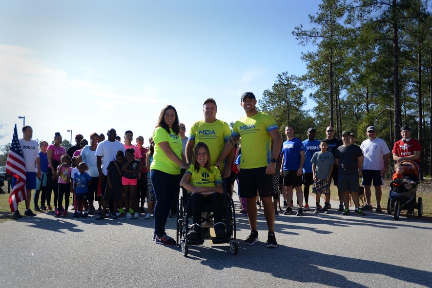 U.S. Air Force Senior Airman Michael Hall, 20th Aerospace Medicine Squadron flight and operation medical technician, center right, stands with his family and fellow runners before a 5K at Shaw Air Force Base, S.C., Feb. 25, 2017. The 20th Medical Group held the race to raise awareness for muscular dystrophy and to help Hall reach his goal of $10,000 in donations for the Muscular Dystrophy Association. (U.S. Air Force photo by Airman 1st Class Kelsey Tucker)