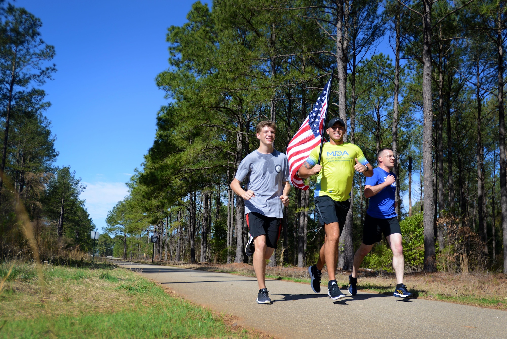 U.S. Air Force Senior Airman Michael Hall, 20th Aerospace Medicine Squadron flight and operation medical technician, center, runs alongside two other participants in a 5K at Shaw Air Force Base, S.C., Feb. 25, 2017. The Muscular Dystrophy Association chose Hall to represent them in the 2017 Boston Marathon on “Team Momentum,” a group that encourages its members to dedicate their miles to individuals with muscular dystrophy, amyotrophic lateral sclerosis (also known as Lou Gehrig’s disease) and other life-threatening diseases. Hall runs for his sister, Danielle, who has lived with muscular dystrophy for 27 years, and his brother DJ, who passed away from the disease when he was 19 months old. (U.S. Air Force photo by Airman 1st Class Kelsey Tucker)