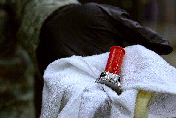 U.S. Air Force Senior Airman Jarrod Adams, 20th Component Maintenance Squadron aerospace propulsion journeyman, holds a magnetic chip detector (MCD) at a test cell facility at Shaw Air Force Base, S.C., March 3, 2017. Because the MCD attracts metal shavings from bearings while an F-16CM Fighting Falcon engine is tested, nondestructive inspection Airmen can pinpoint which bearings, if any, need replacement. (U.S. Air Force photo by Airman 1st Class Kathryn R.C. Reaves)