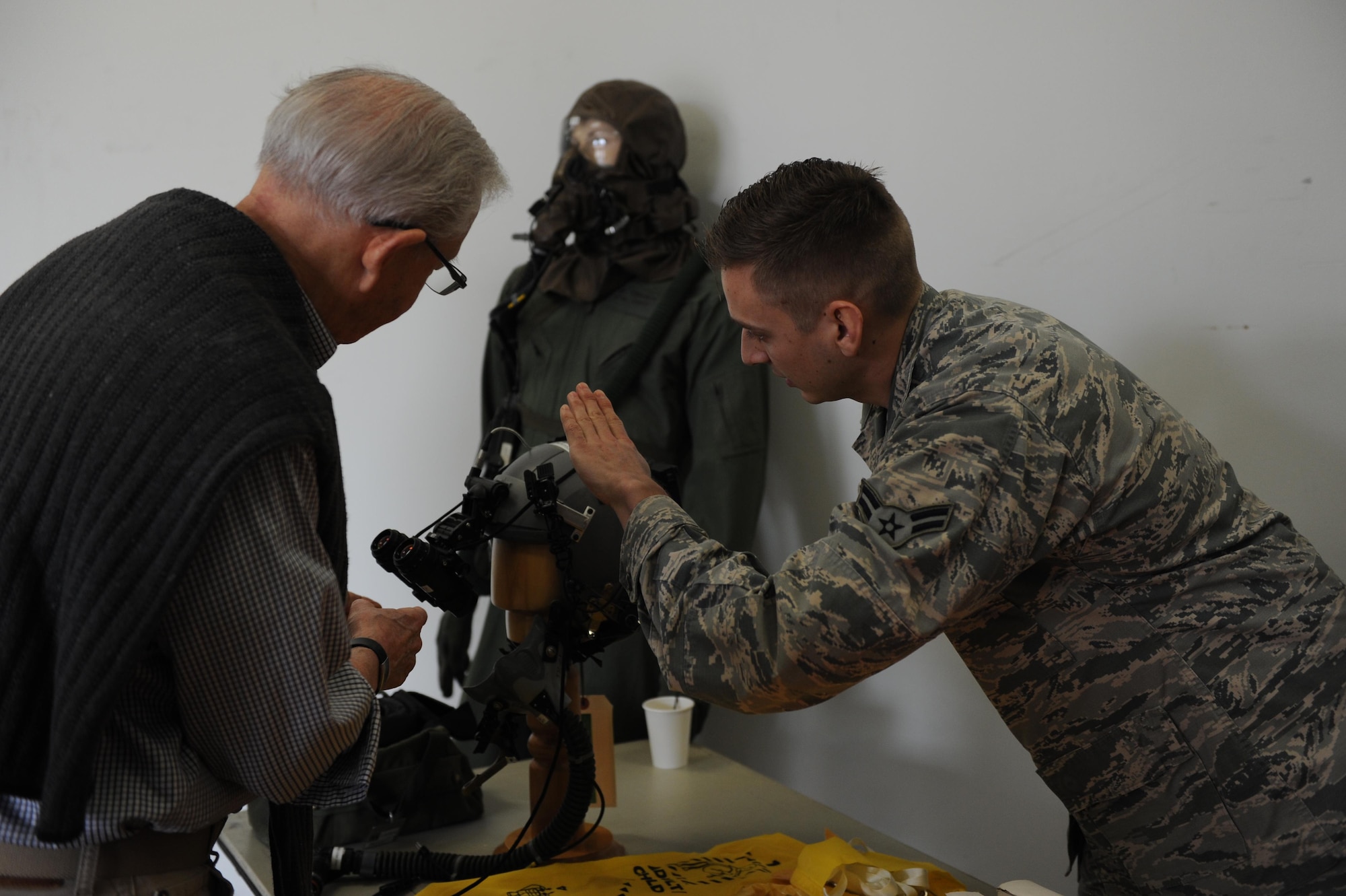 U.S. Air ForceAirman 1st Class Travis Jones, 19th Operation Support Squadron Aircrew Flight Equipment technition, shows off the nightvision goggles the pilots use to Mr. David Egan , a pilot for the 41st AS in 1963, during a reunion March 24, 2017, on Little Rock Air Force Base, Ark. The reunion honored the 75th anniversary of the 41st AS. (U.S. Air Force photo by Airman 1st Class Grace Nichols)