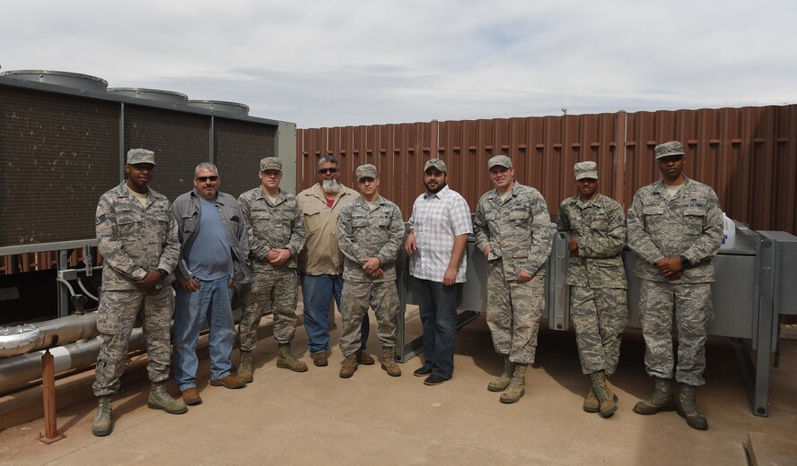U.S. Air Force Airmen and contractors from the 7th Civil Engineering Squadron heating, ventilation and air-conditioning shop install and maintain energy efficient air conditioning units at Dyess Air Force Base, Texas, March 6, 2017. One building the HVAC shop helped update was the base fitness center, with a new AC unit and updated backup units. (U.S. Air Force photo by Senior Airman Alexander Guerrero)