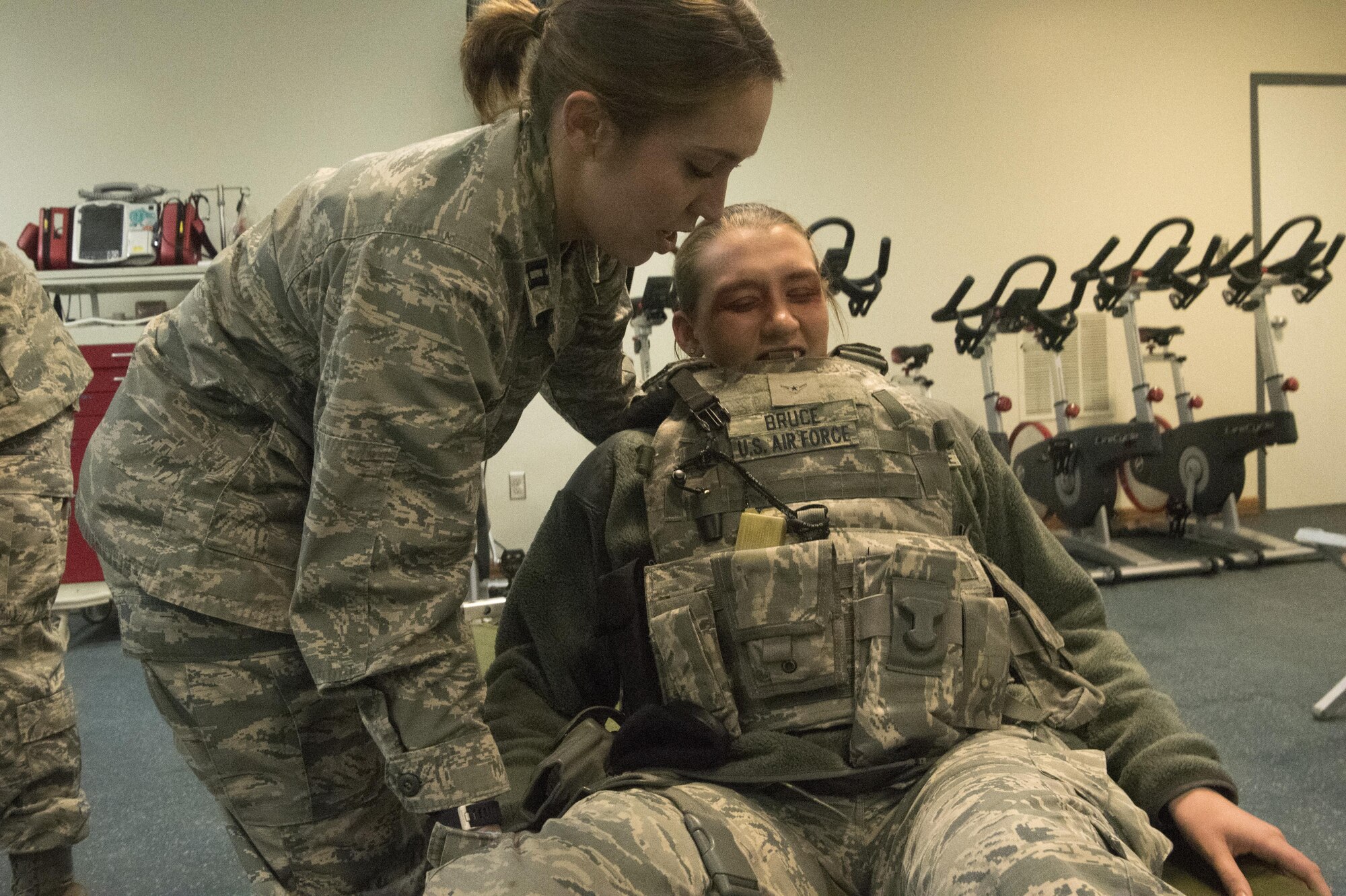 PETERSON AIR FORCE BASE, Colo. – Capt. Emma Pinkerton, Cheyenne Mountain Air Force Station Medical Aid Station nurse, assists a mock victim of a mass casualty exercise during button-up contingency triage training at the Cheyenne Mountain AFS, Colo., March 3, 2017. The training is designed to stress Cheyenne Mountain AFS medical responders, who are on call from Peterson Air Force Base Medical Clinic, to simulate the stress that a future buttoned up mass casualty event could cause. (U.S. Air Force photo by Steve Kotecki)