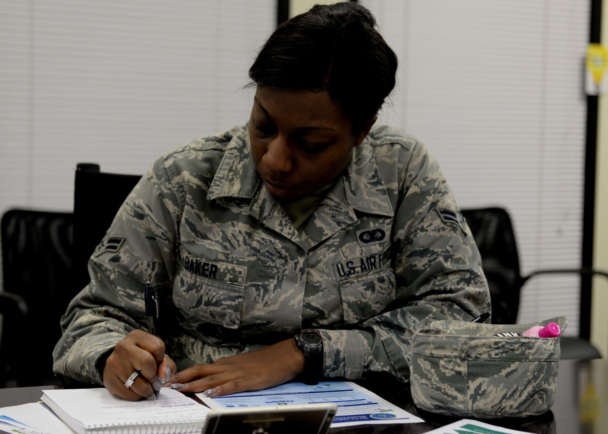 U.S. Air Force Airman 1st Class Lalah Baker, 97th Air Mobility Wing administration apprentice takes notes during a financial class for Military Saves Week, March 1, 2017, at Altus Air Force Base, Oklahoma. The Military Saves Week classes help military members manage their money and gain more information on financial opportunities. (U.S. Air Force Photo by Airman 1st Class Jackson N. Haddon/Released).