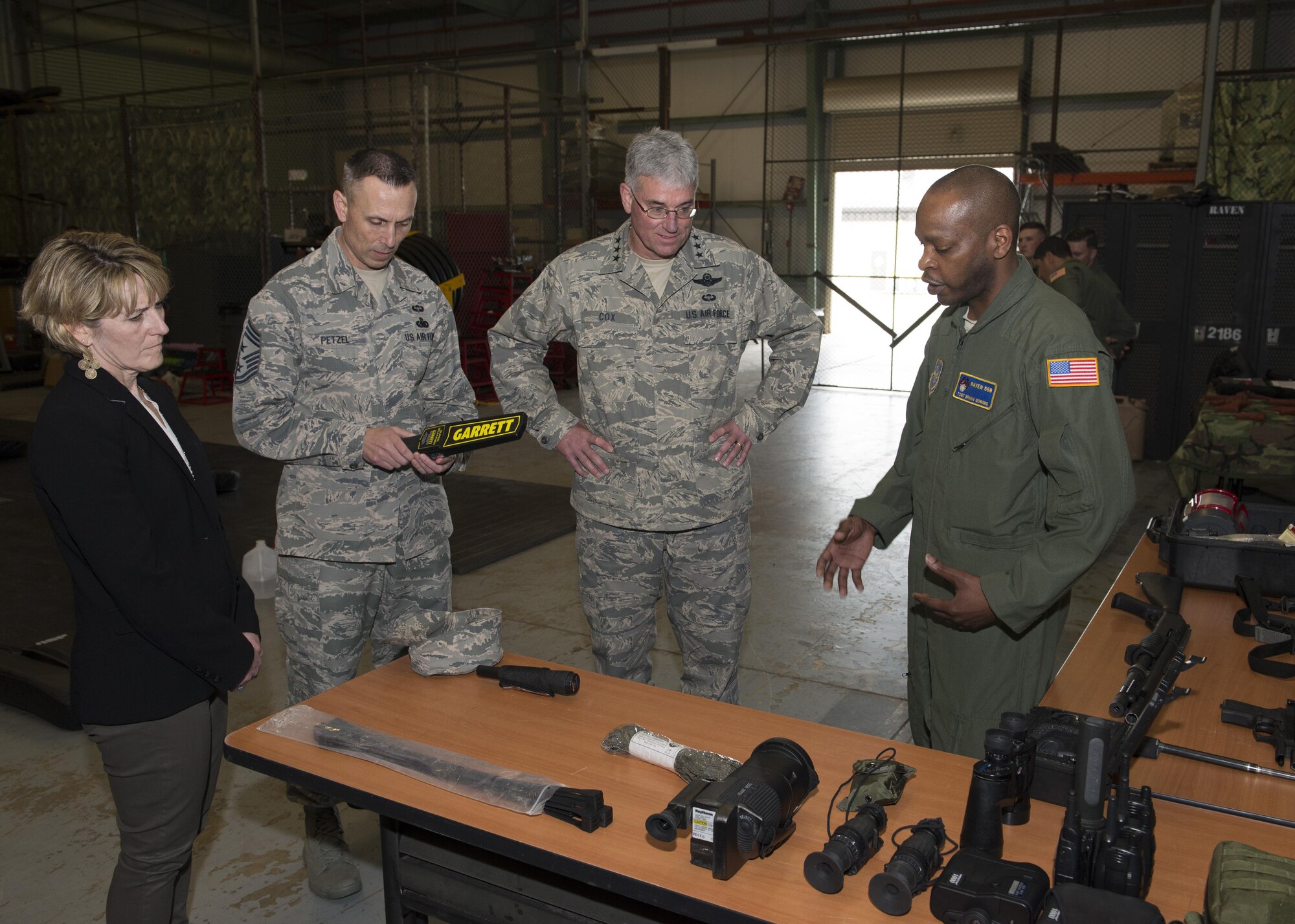 Tech. Sgt. Brian Goring, 436th Security Forces Squadron Phoenix Raven, gives an equipment and weapons briefing to Lt. Gen. Sam Cox, 18th Air Force commander, his wife, Tammy Cox, and Chief Master Sgt. Todd Petzel, 18th AF command chief, during a tour March 1, 2017, at Dover Air Force Base, Del. The Ravens put on a combative demonstration to help them better understand the Raven’s mission. Ravens provide close-in security for aircraft transiting airfields where security is unknown or additional security is needed to counter local threats. (U.S. Air Force photo by Senior Airman Zachary Cacicia)