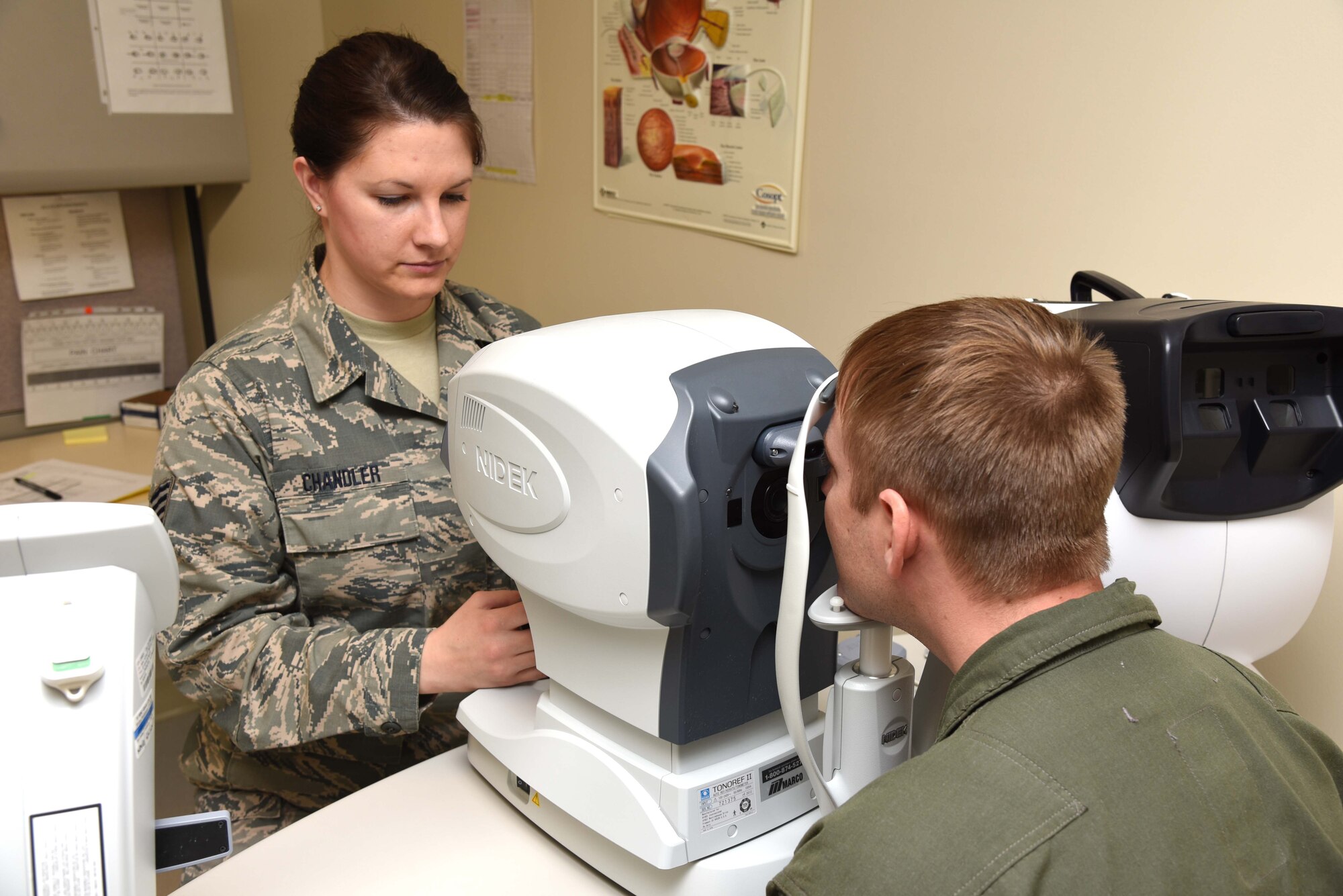 Staff Sgt. Kristen Chandler, 403rd Aeromedical Staging Squadron noncommissioned officer in charge, uses a non-contact tonometer during an optometry exam to check the eye pressure of Master Sgt. Joseph Helm, 815th Airlift Squadron training noncommissioned officer in charge Feb. 10 at Keesler Air Force Base, Mississippi. One of the roles of ASTS is to make sure that the wing’s Citizen Airmen are healthy and fit for service worldwide. (U.S. Air Force photo/Tech. Sgt. Ryan Labadens)