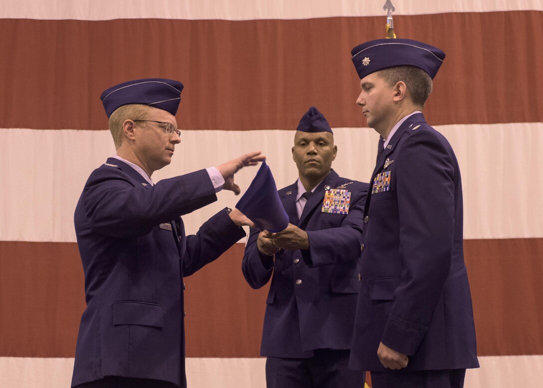 Col. Matthew Atkins, 361st Intelligence, Surveillance and Reconnaissance Group Commander, Hurlburt Field, Fla., unfurls the 361st guidon during an assumption of command ceremony hosted by the 137th Special Operations Wing, March 6, 2017, at Will Rogers Air National Guard Base, Oklahoma City. Lt. Col. Stephen McFadden received the guidon as he took command of the 306th Intelligence Squadron, formerly located at Beale Air Force Base, Calif., upon its activation at WRANGB. (U.S. Air National Guard photo by Staff Sgt. Kasey Phipps)