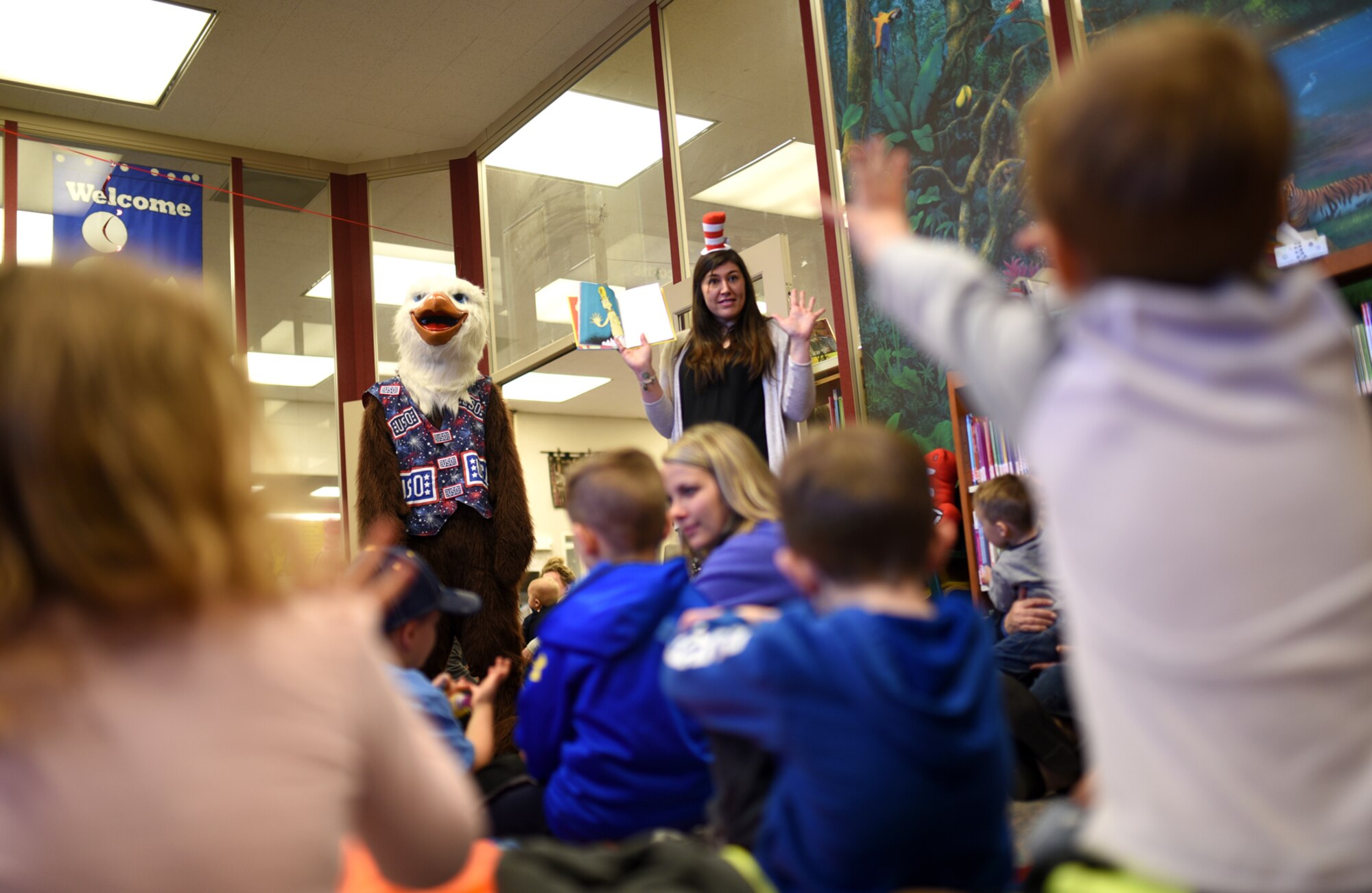 PETERSON AIR FORCE BASE, Colo. – Ernie the Eagle and Katie Kerry, United Service Organization Colorado Springs program coordinator, reads a Dr. Seuss story aloud to children in the library at Peterson Air Force Base, Colo., March 2, 2017. Ernie and Kerry read “One fish, two fish, red fish, blue fish” to the children while encouraging them to participate in the story. (U.S. Air Force photo by Airman 1st Class Dennis Hoffman)