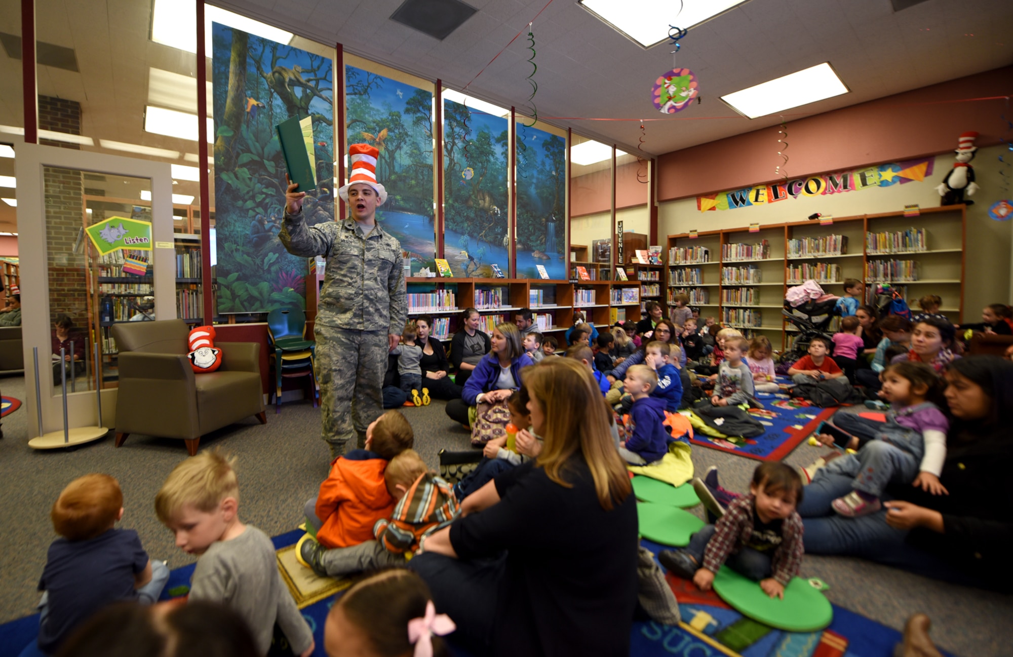 PETERSON AIR FORCE BASE, Colo. – Lt. Col. David Wilson, 21st Force Support Squadron commander, reads a Dr. Suess story to children in the library at Peterson Air Force Base, Colo., March 2, 2017. Wilson read a personal Dr. Seuss favorite, “Oh the places you’ll go!” to the parents and children. (U.S. Air Force photo by Airman 1st Class Dennis Hoffman)