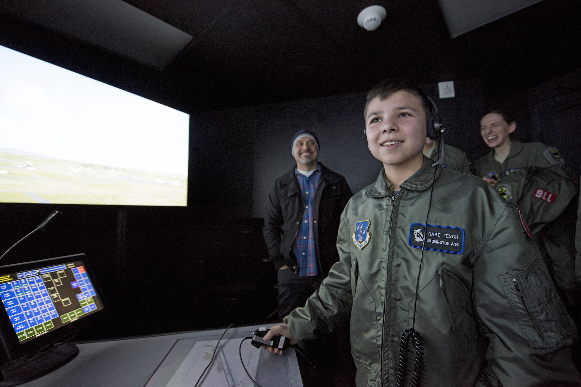 "Pilot for a Day" candidate Gabe Tesch issues landing instructions to a virtual pilot during his visit to the air traffic control simulator Mar. 1, 2017, at Fairchild Air Force Base, Washington. Gabe spent the day visiting several work centers throughout the base receiving hands on instruction and briefings on what it takes to be a KC-135 Stratotanker pilot. The "Pilot for a Day" program provides disadvantaged or seriously ill children a chance to spend the day with members of the Washington Air National Guard training as an honorary pilot. (U.S. Air Force photo by Master Sgt. Michael Stewart/Released) 

