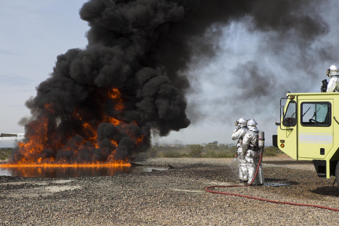 Aircraft Rescue and Firefighting Marines with Headquarters and Headquarters Squadron (HHS) and Marine Wing Support Squadron (MWSS) 473 conduct a controlled burn exercise at the ARFF training pit at Marine Corps Air Station Miramar, Calif., March 4. Marines with ARFF are responsible for any fire or hazardous material mishap that involves an aircraft. (U.S. Marine Corps photo by Lance Cpl. Liah Kitchen/Released)